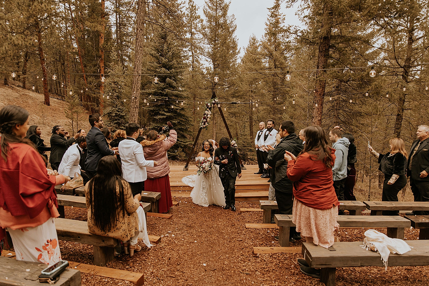 Bride and groom walking down aisle at outdoor ceremony in Colorado | McArthur Weddings and Events
