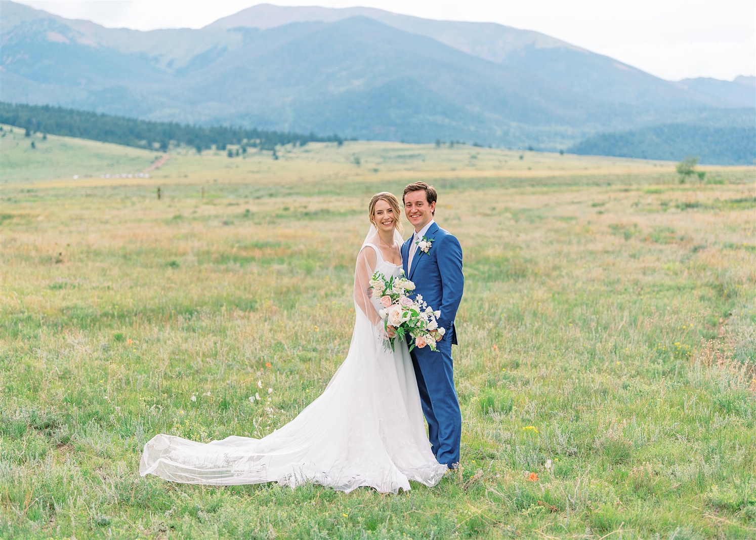 Bride and groom standing in front of mountains at Three Peaks Ranch | McArthur Weddings and Events
