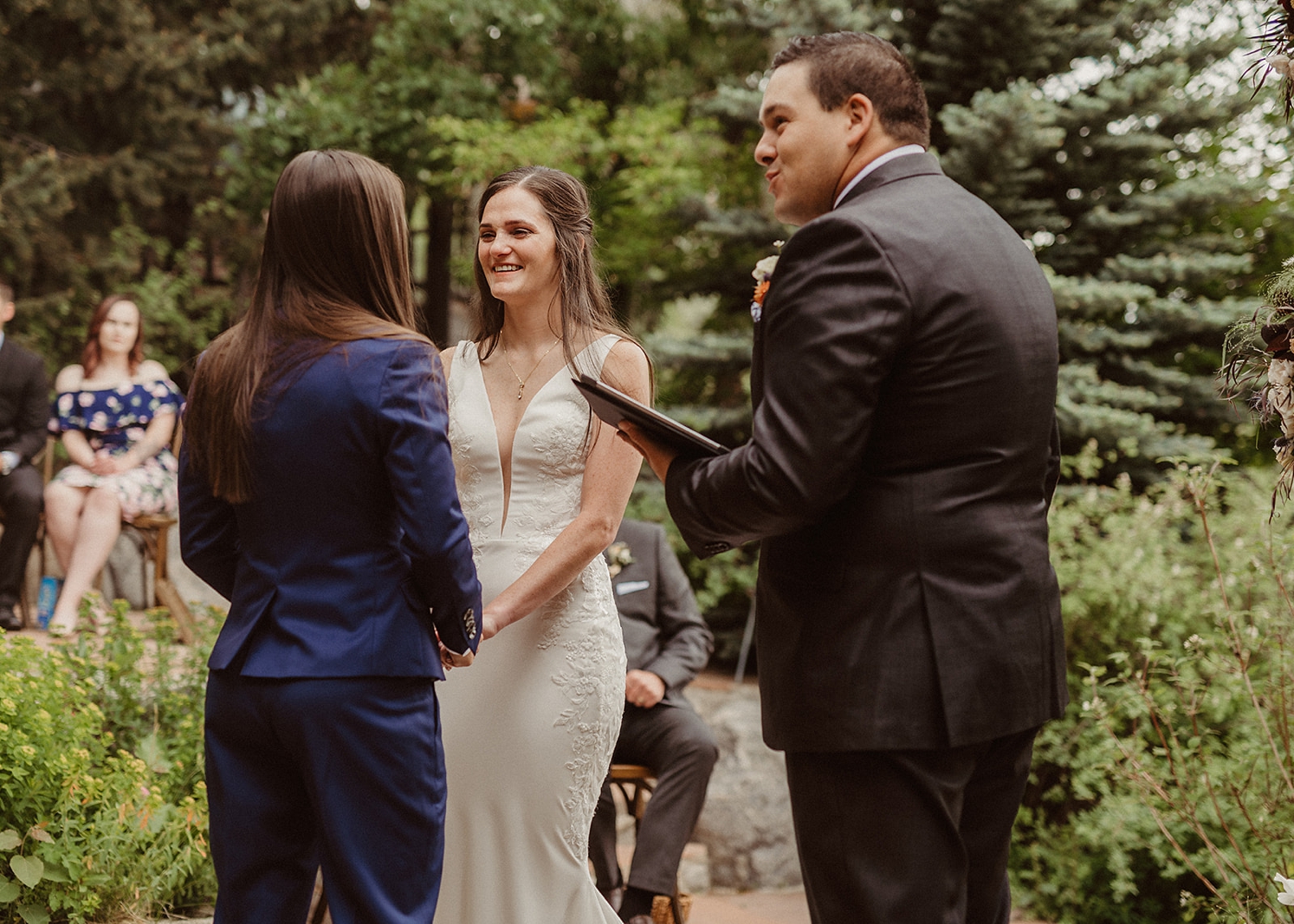 Couple holding hands during ceremony at Colorado Airbnb wedding | McArthur Weddings and Events