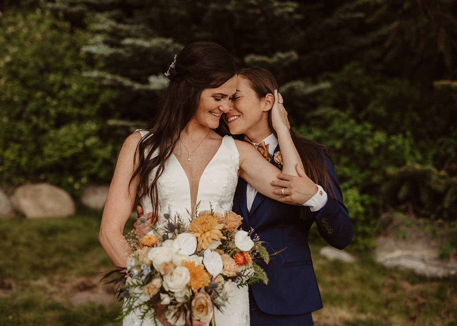 Partners standing next to each other touching heads at Colorado Airbnb wedding | McArthur Weddings and Events