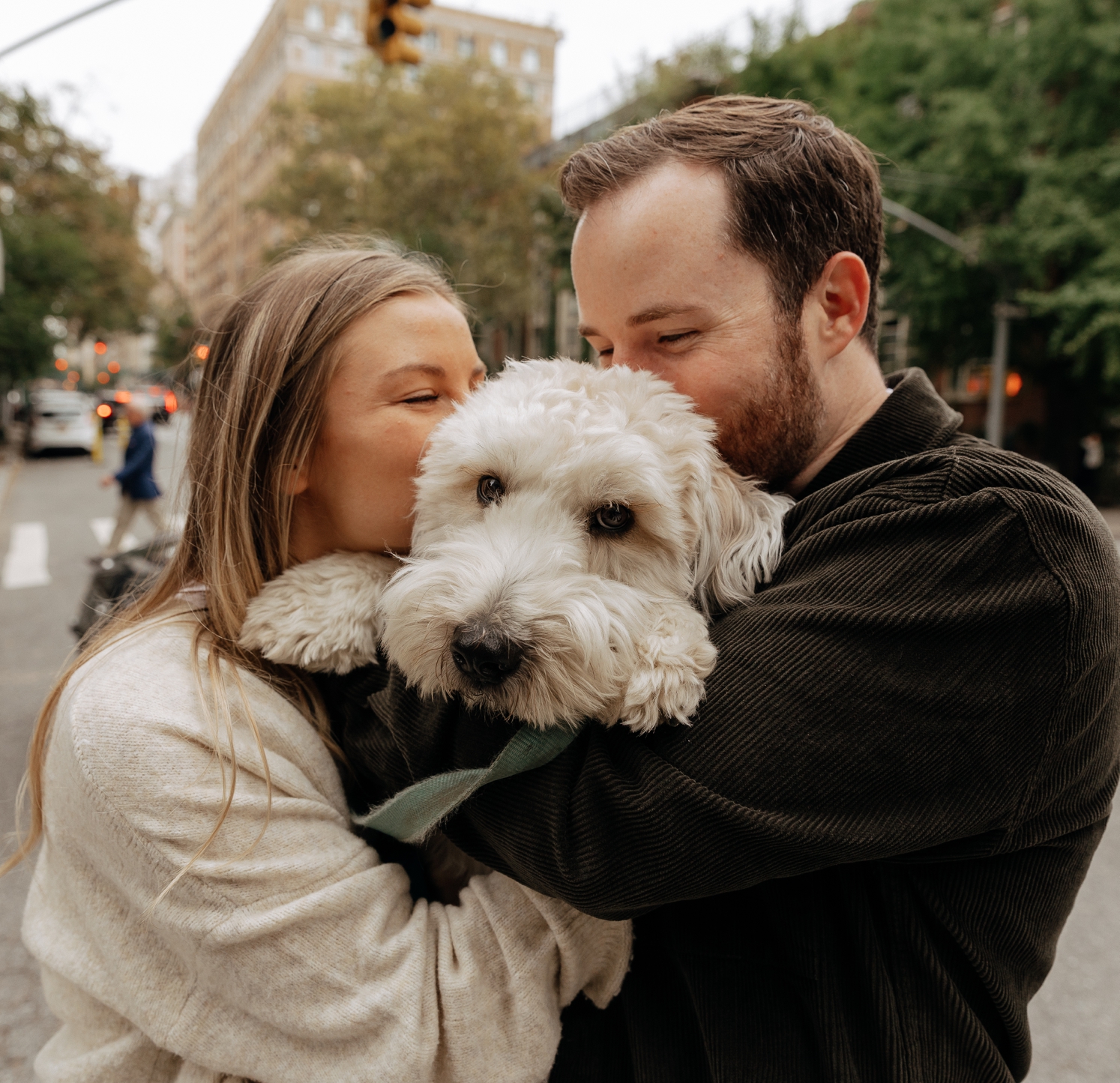 Couple kissing their golden doodle during engagement shoot | McArthur Weddings and Events
