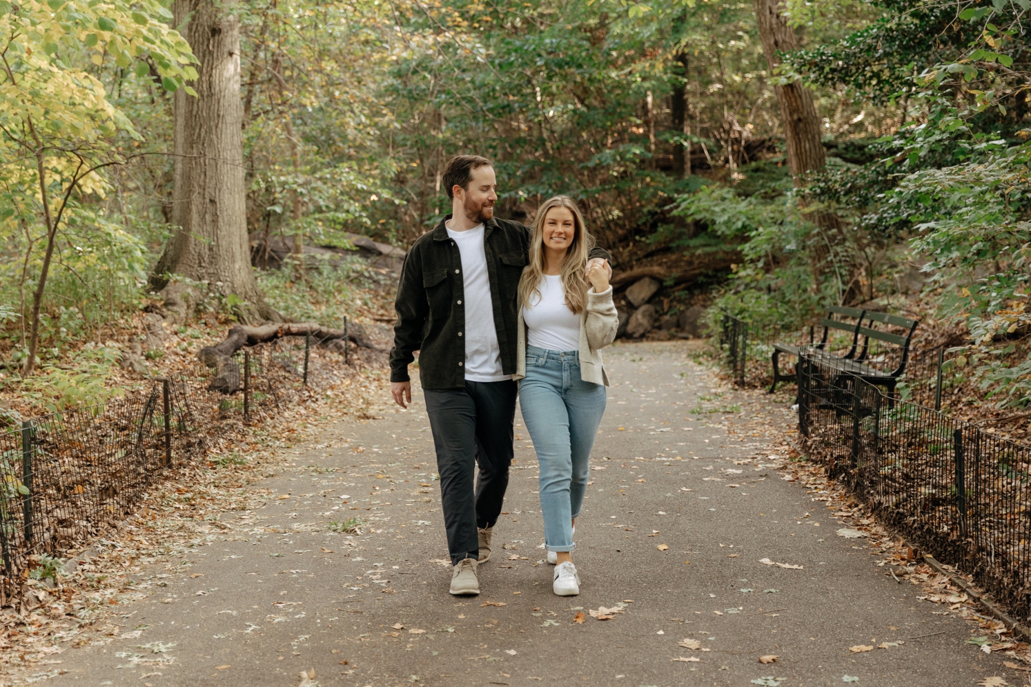 Newly engaged couple walking through Central Park during engagement shoot | McArthur Weddings and Events