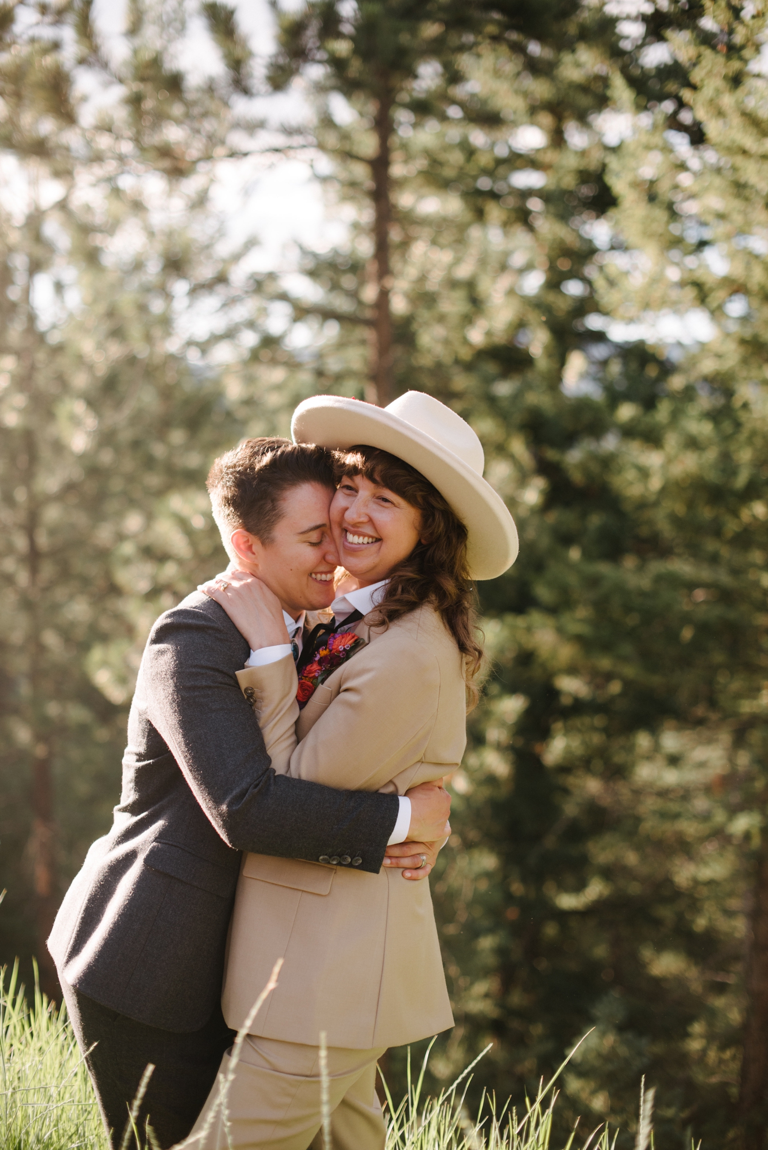 Couple hugging each other and laughing outdoors at Colorado wedding | McArthur Weddings and Events