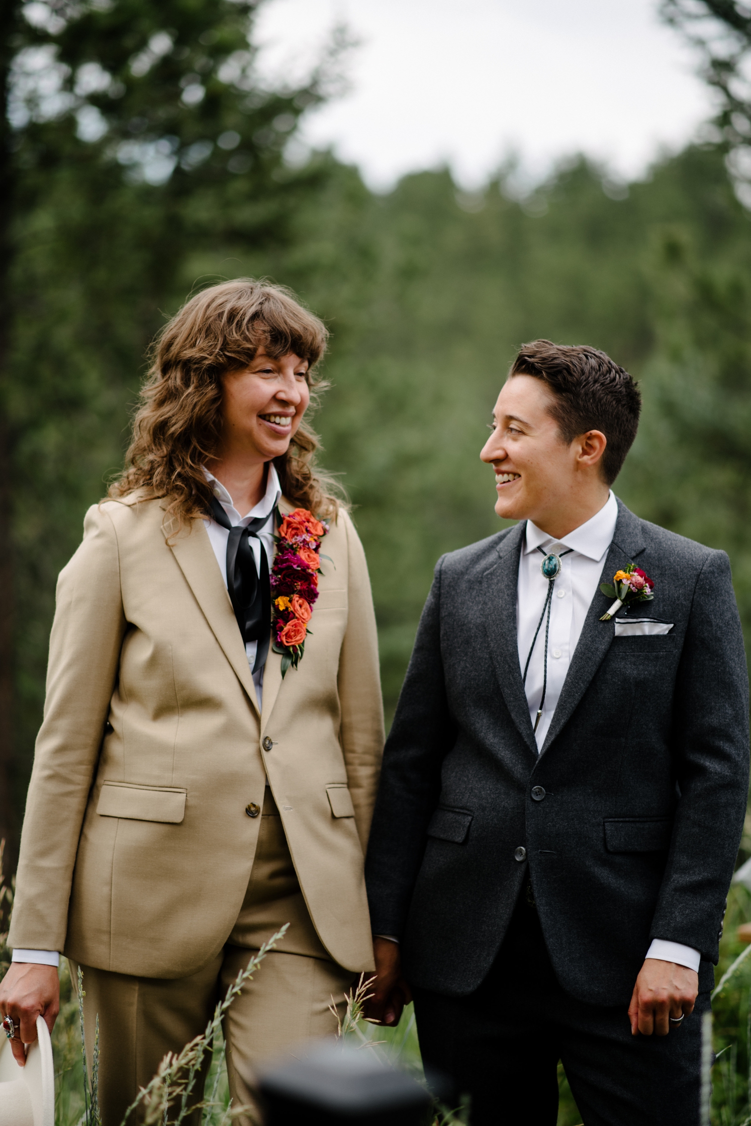 Couple holding hands and smiling during photos before LGBTQ wedding | McArthur Weddings and Events
