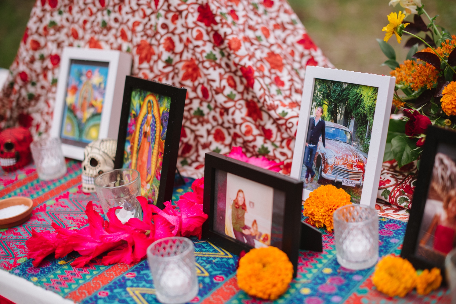 Photos, candles, and marigolds on Mexican ofrenda at wedding ceremony | McArthur Weddings and Events