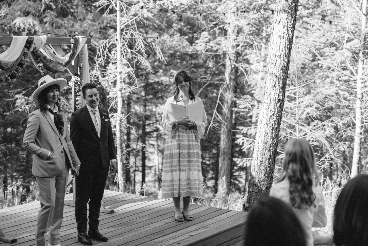 Couple looking at daughter while she speaks at LGBTQ wedding ceremony | McArthur Weddings and Events
