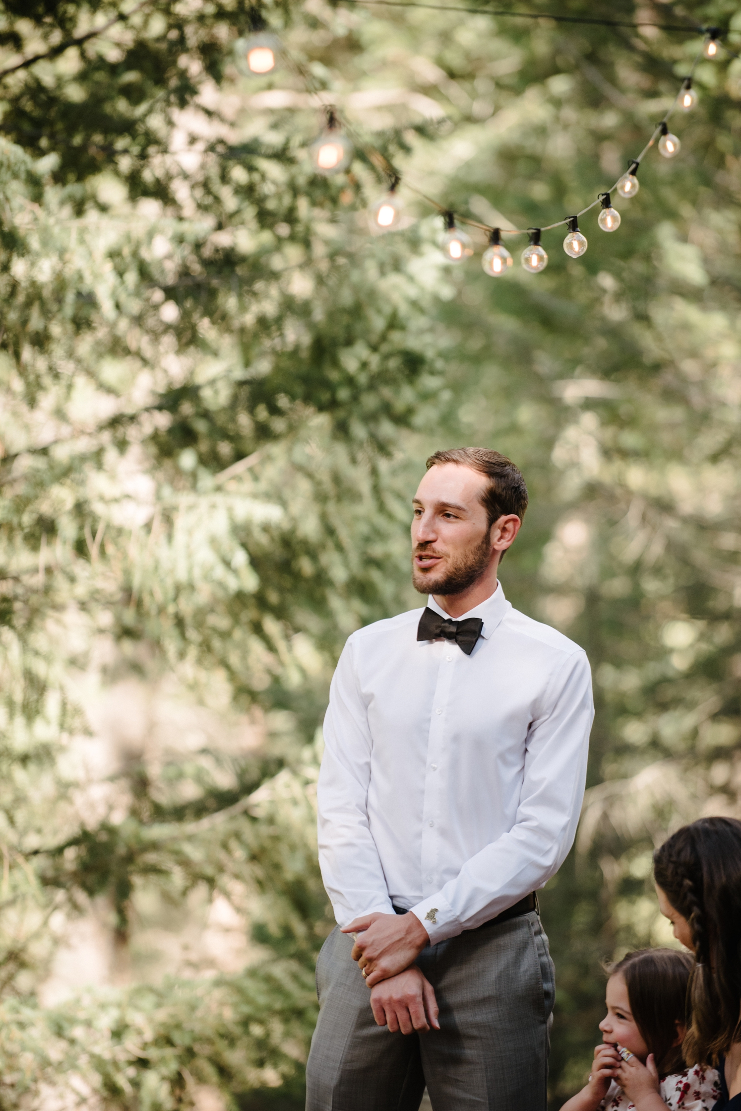 Wedding guest speaking to couple during wedding ceremony | McArthur Weddings and Events
