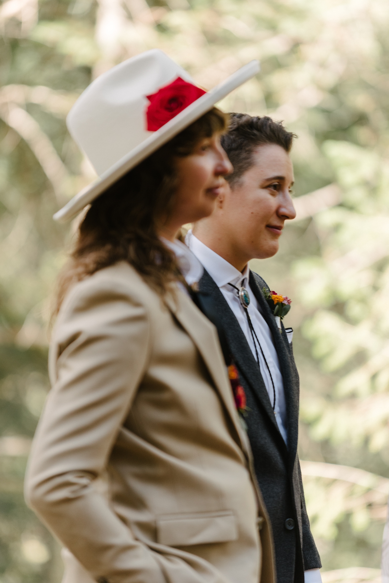 Couple looking at guests during LGBTQ wedding | McArthur Weddings and Events