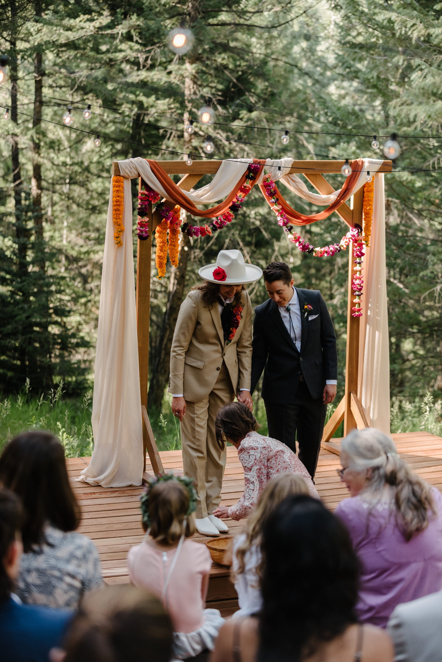 Guest placing offering in basket during LGBTQ wedding at Juniper Mountain House | McArthur Weddings and Events