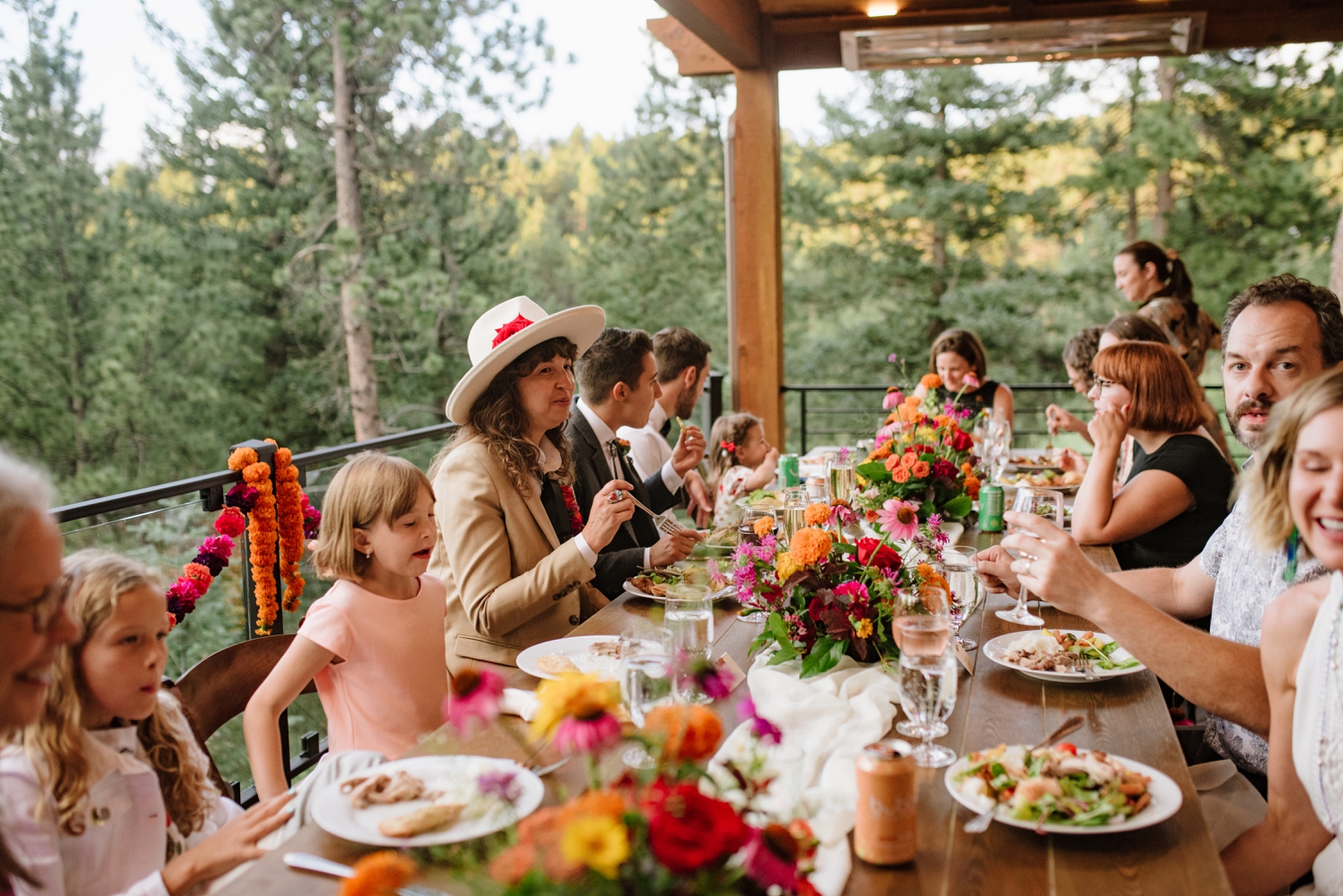 Couple enjoying dinner with guests at Juniper Mountain House | McArthur Weddings and Events