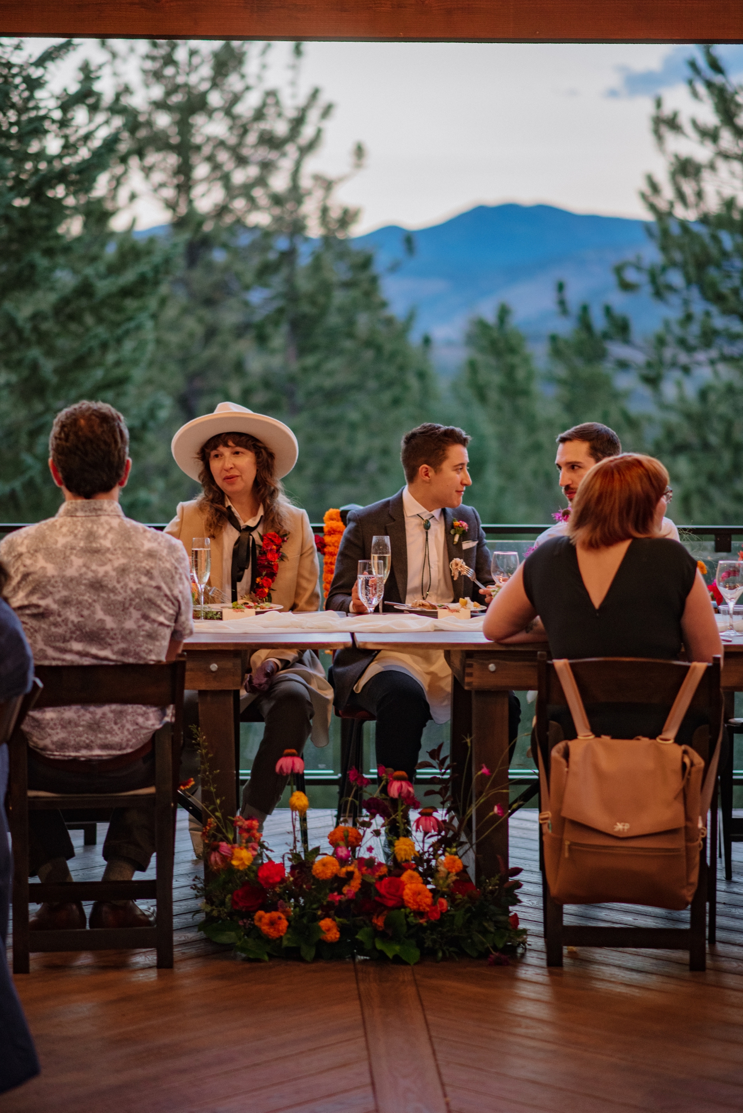 Couple talking to guests during dinner at Juniper Mountain House | McArthur Weddings and Events