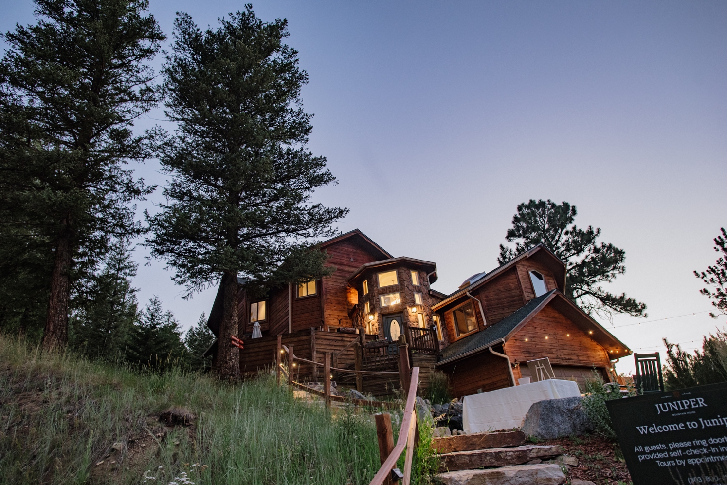 Juniper Mountain House lit up at sunset | McArthur Weddings and Events