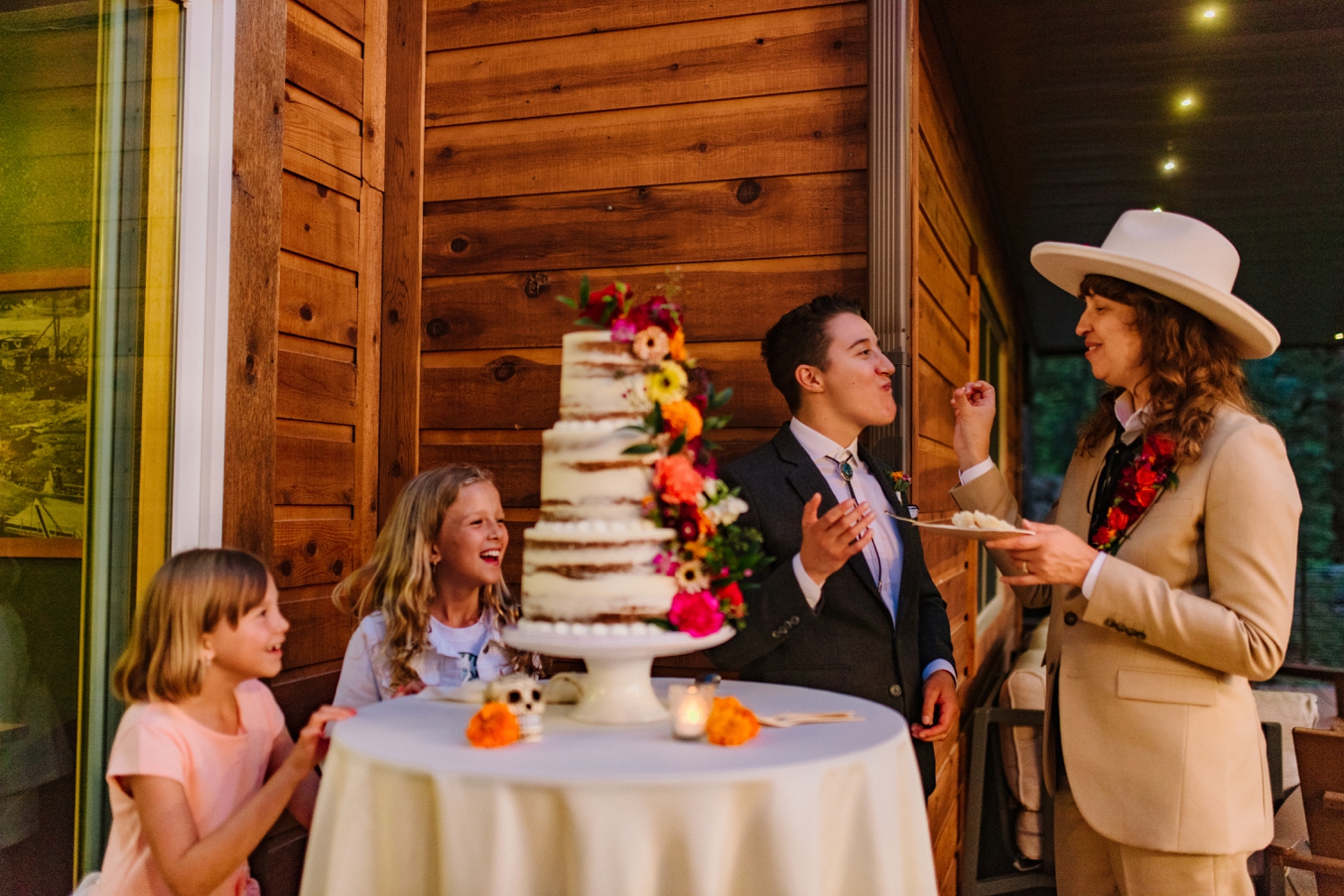 Couple cutting cake with daughters watching | McArthur Weddings and Events