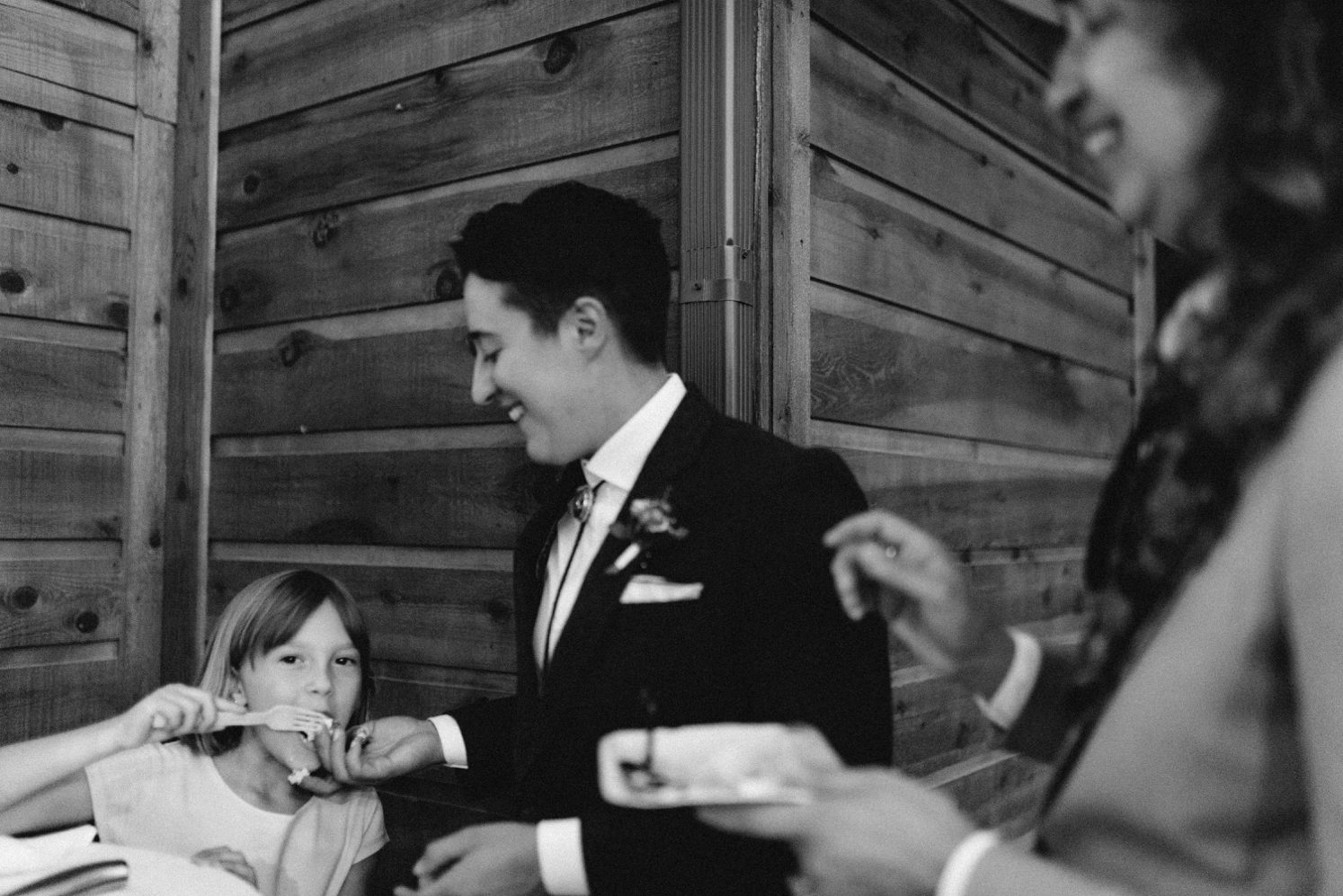 Daughter taking bite of cake at wedding | McArthur Weddings and Events