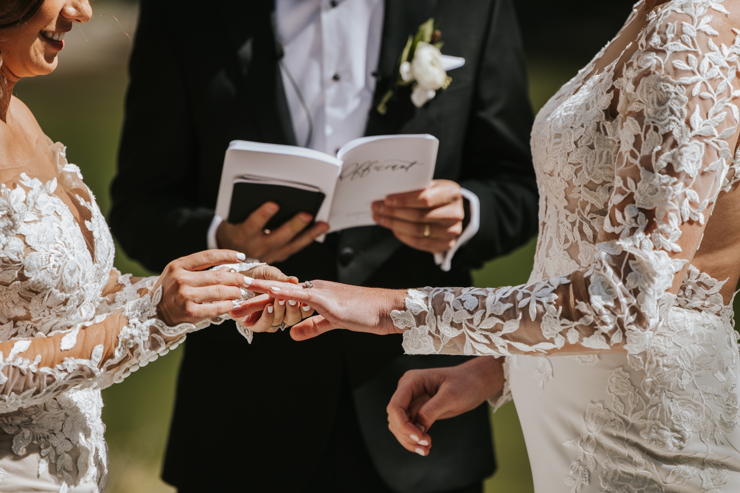Brides exchanging rings at Telluride wedding | McArthur Weddings and Events