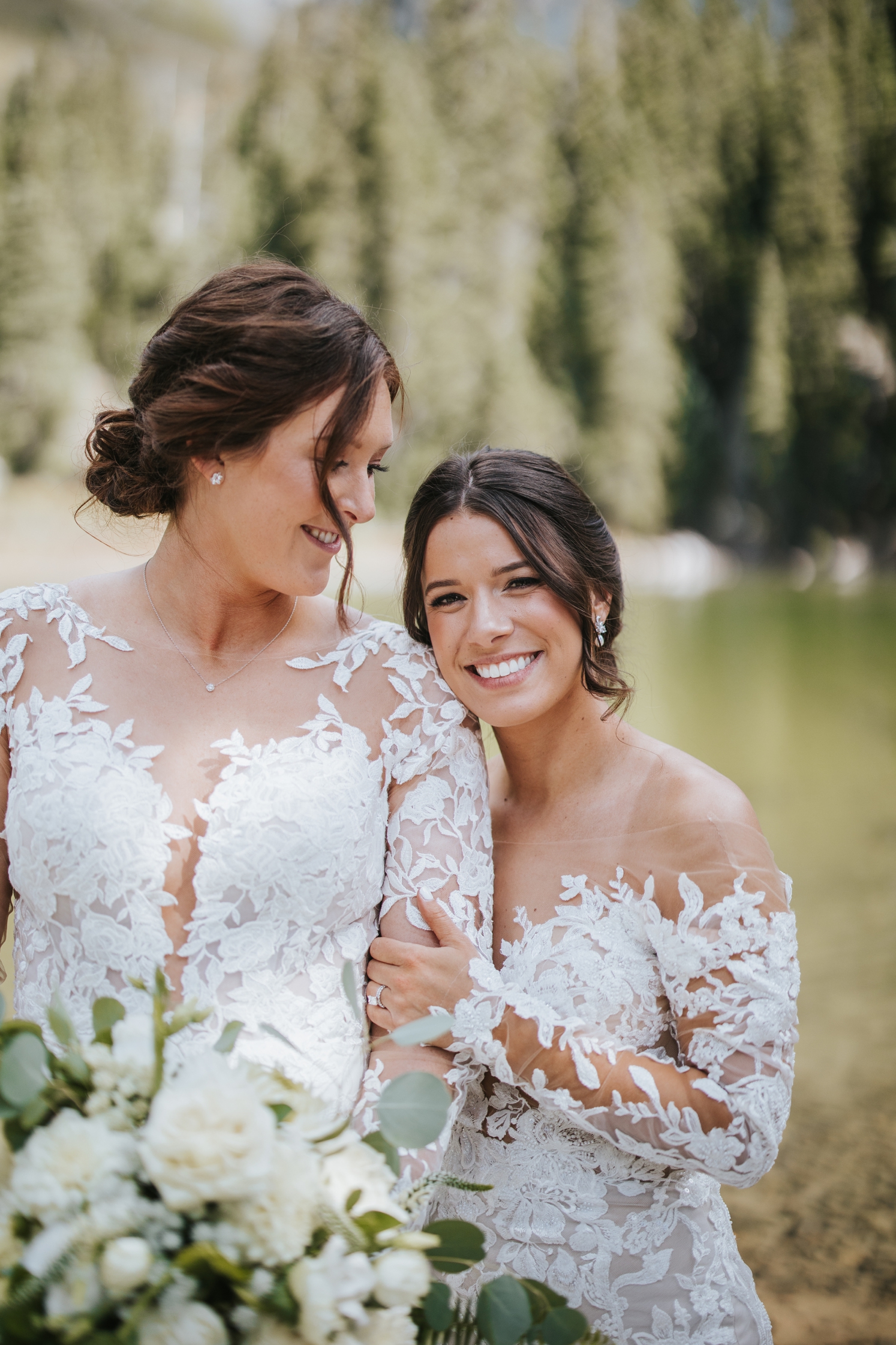 Bride leaning head against partner's shoulder | McArthur Weddings and Events