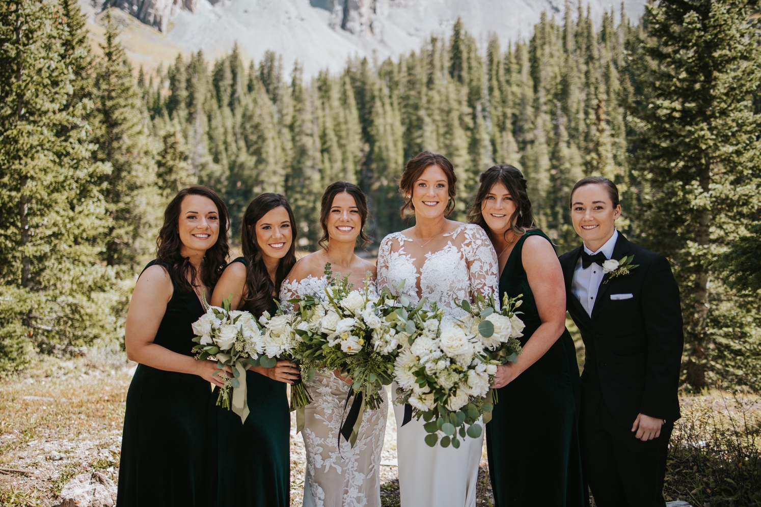 Couple posing with wedding party after Telluride wedding | McArthur Weddings and Events