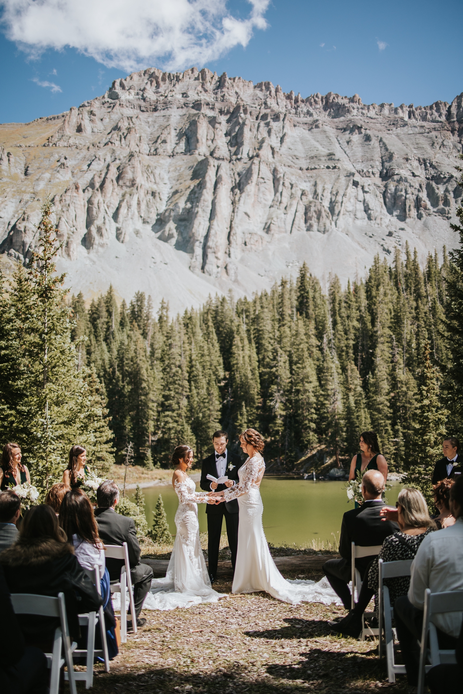 Couple holding hands at lakeside wedding ceremony in Telluride | McArthur Weddings and Events