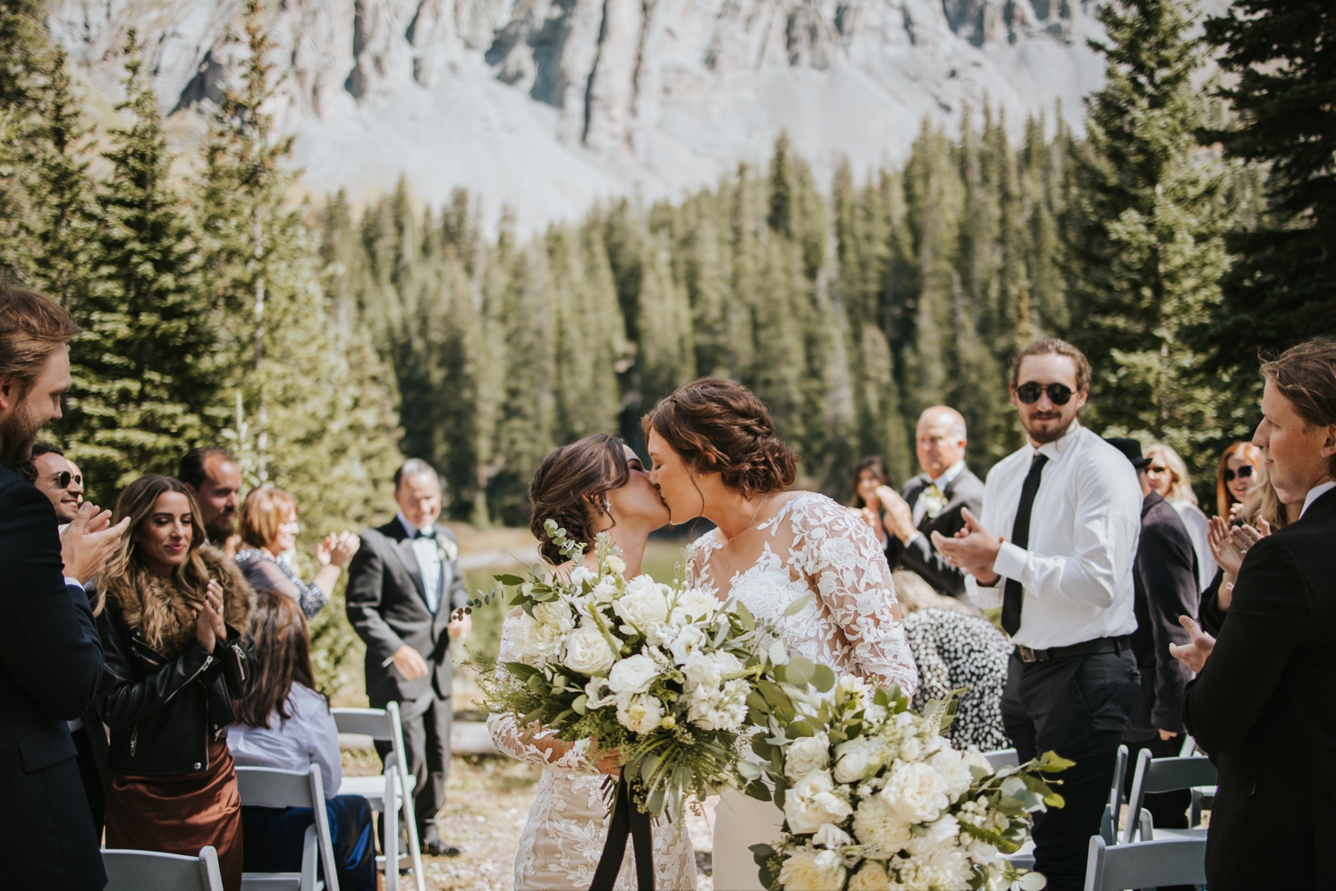 Brides kissing after wedding ceremony in Telluride | McArthur Weddings and Events