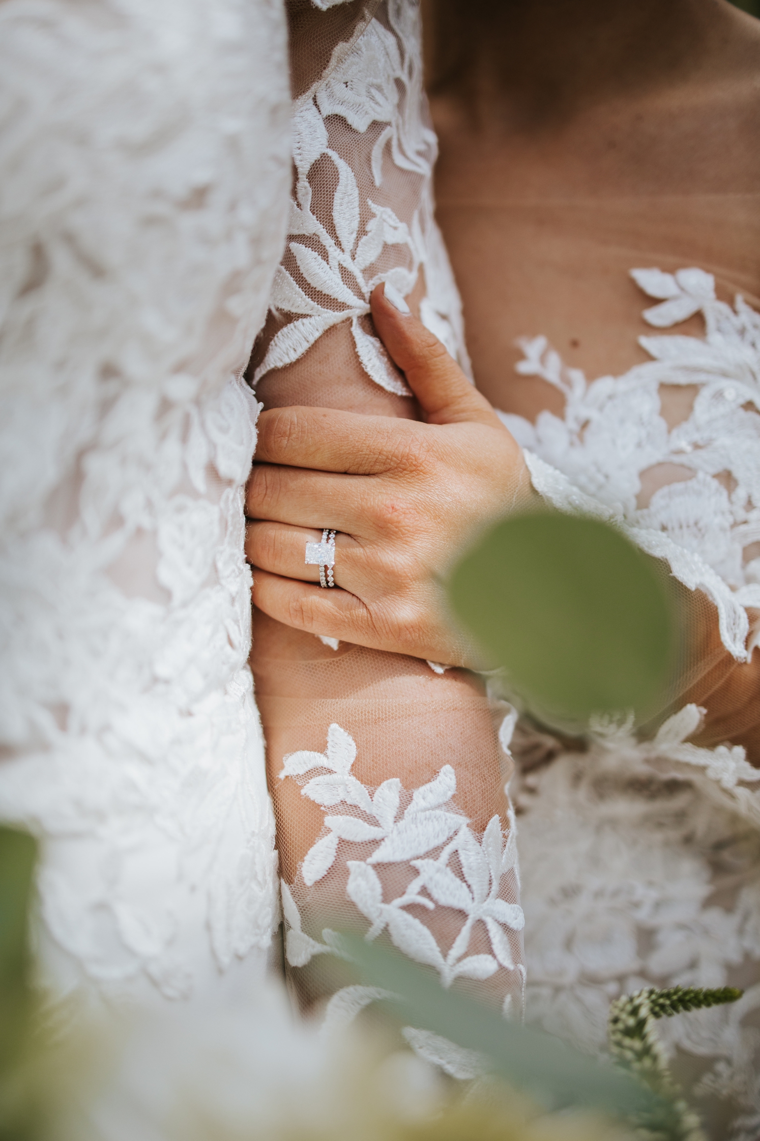 Woman's hand on partner's arm showing off wedding ring | McArthur Weddings and Events