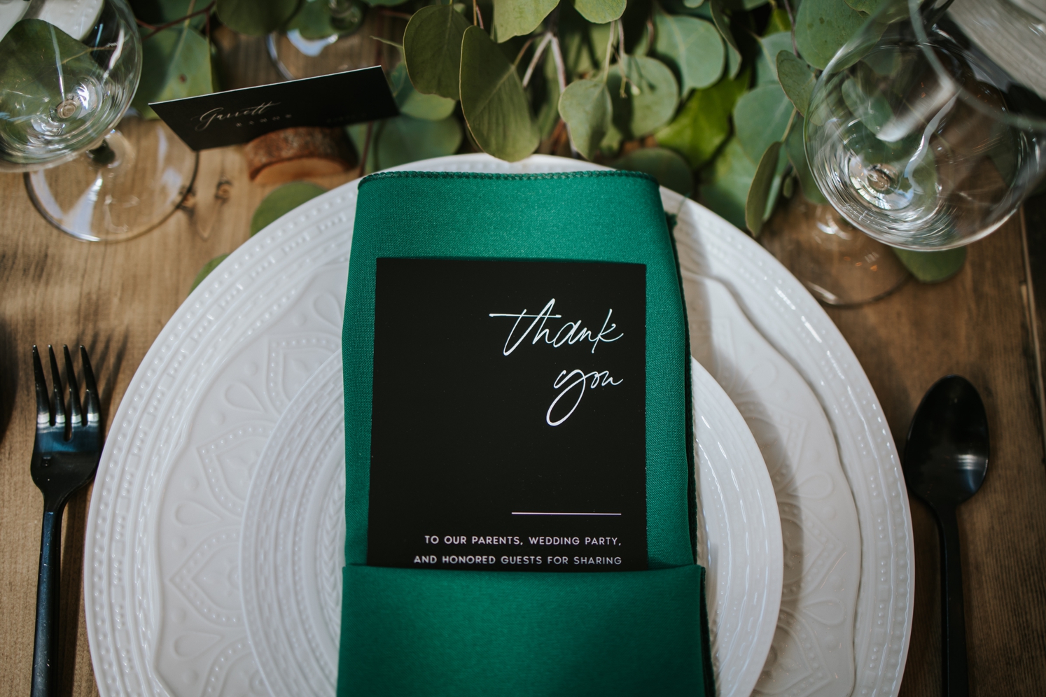 Green napkins with black paper goods and black flatware | McArthur Weddings and Events