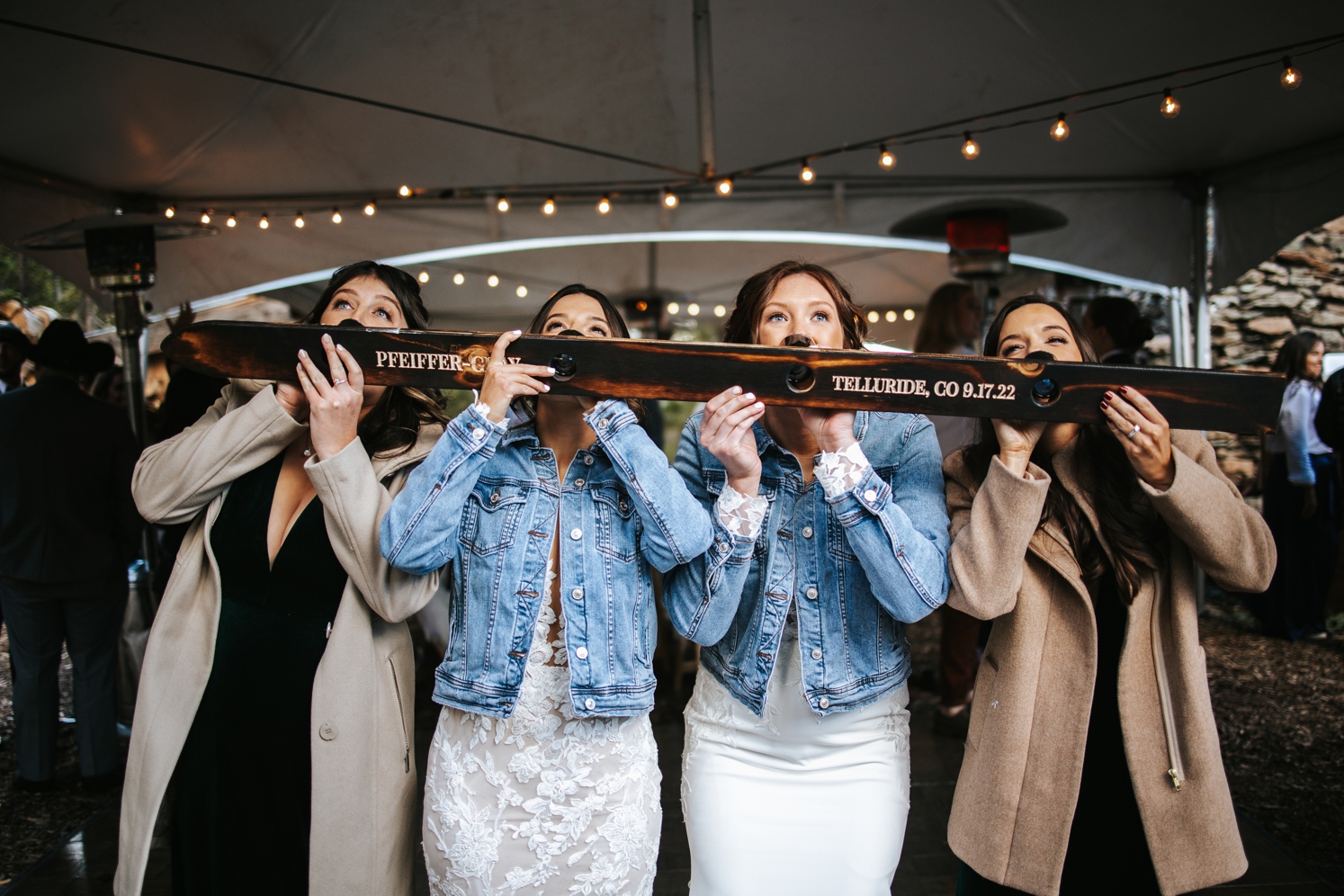 Brides doing shot ski with wedding guests at Telluride wedding | McArthur Weddings and Events