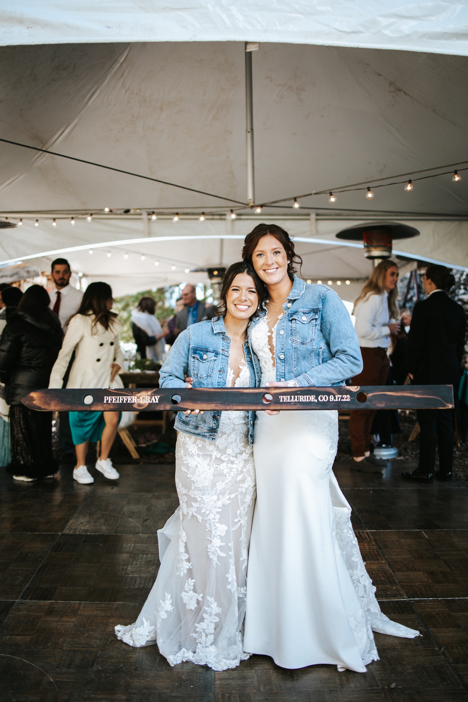 Brides posing with guest book shot ski | McArthur Weddings and Events