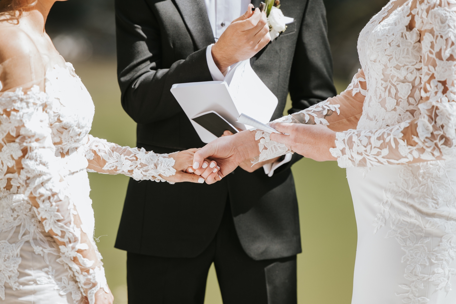 Couple holding hands during reading of vows at Telluride wedding | McArthur Weddings and Events