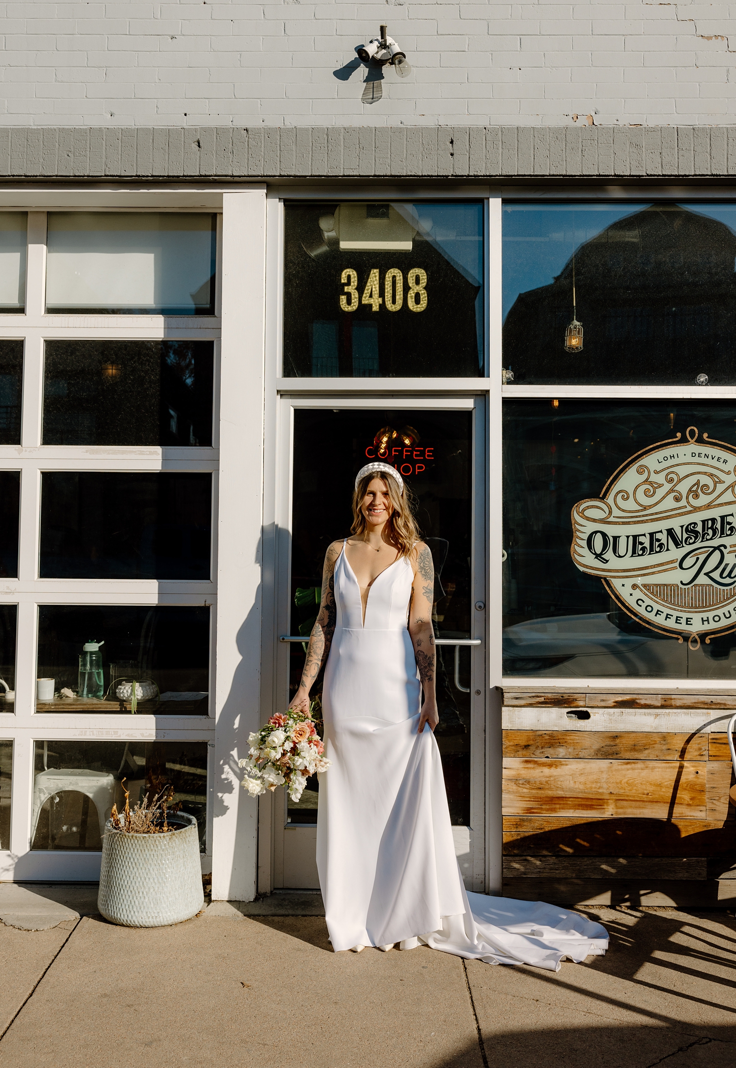 Bride holding bouquet standing in front of Queensbury Rules Coffee House | McArthur Weddings and Events