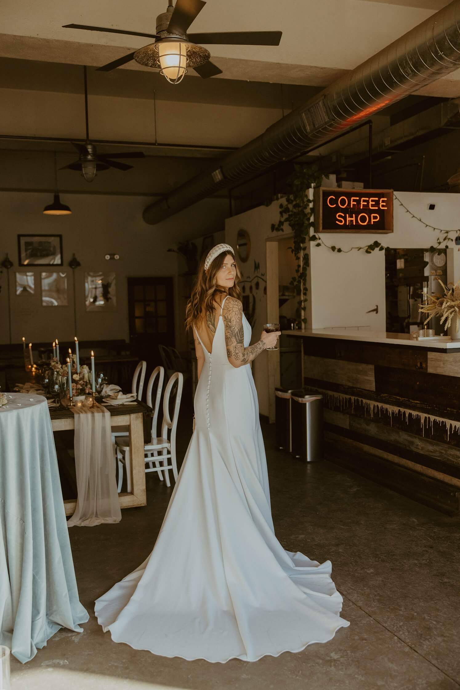 Bride looking over shoulder holding espresso martini at Queensbury Rules Coffee House | McArthur Weddings and Events