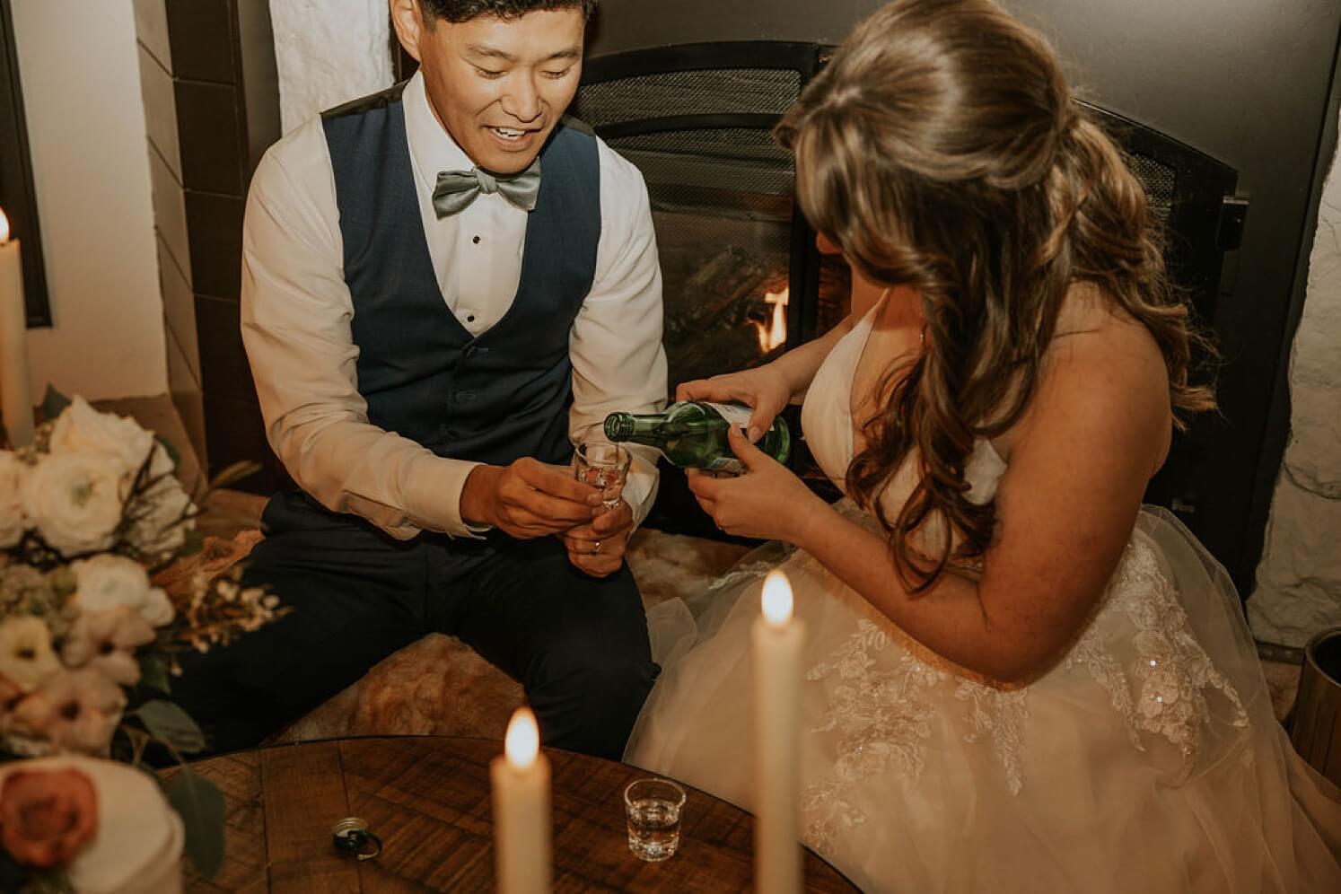Bride pouring soju into custom shot glass for groom | McArthur Weddings and Events
