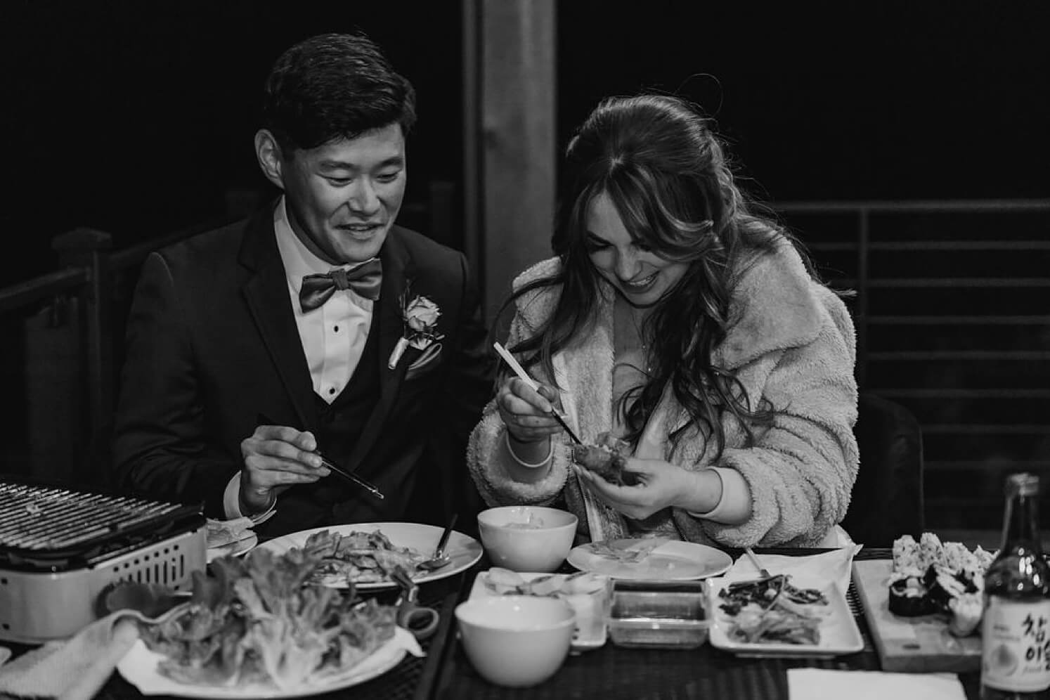Bride and groom eating Korean BBQ at Juniper Mountain House | McArthur Weddings and Events
