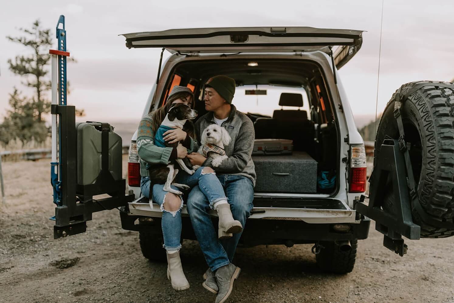 Bride and groom sitting with dogs in the back of their 4Runner before Colorado elopement | McArthur Weddings and Events