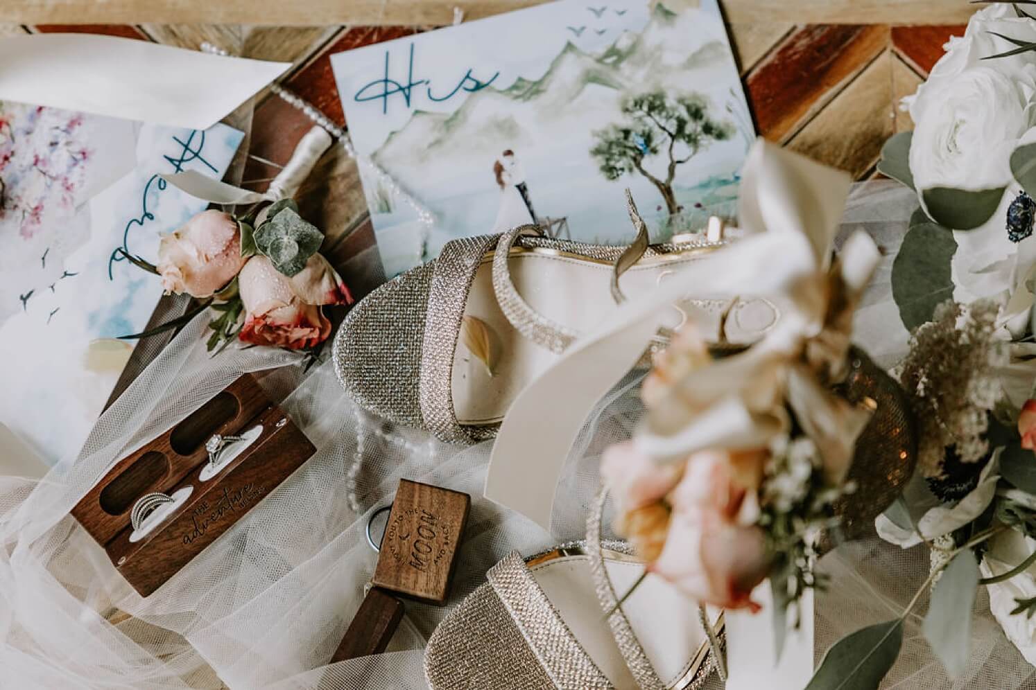 Wedding day details including watercolor vow bards, crystal encrusted shoes, and wooden ring box | McArthur Weddings and Events