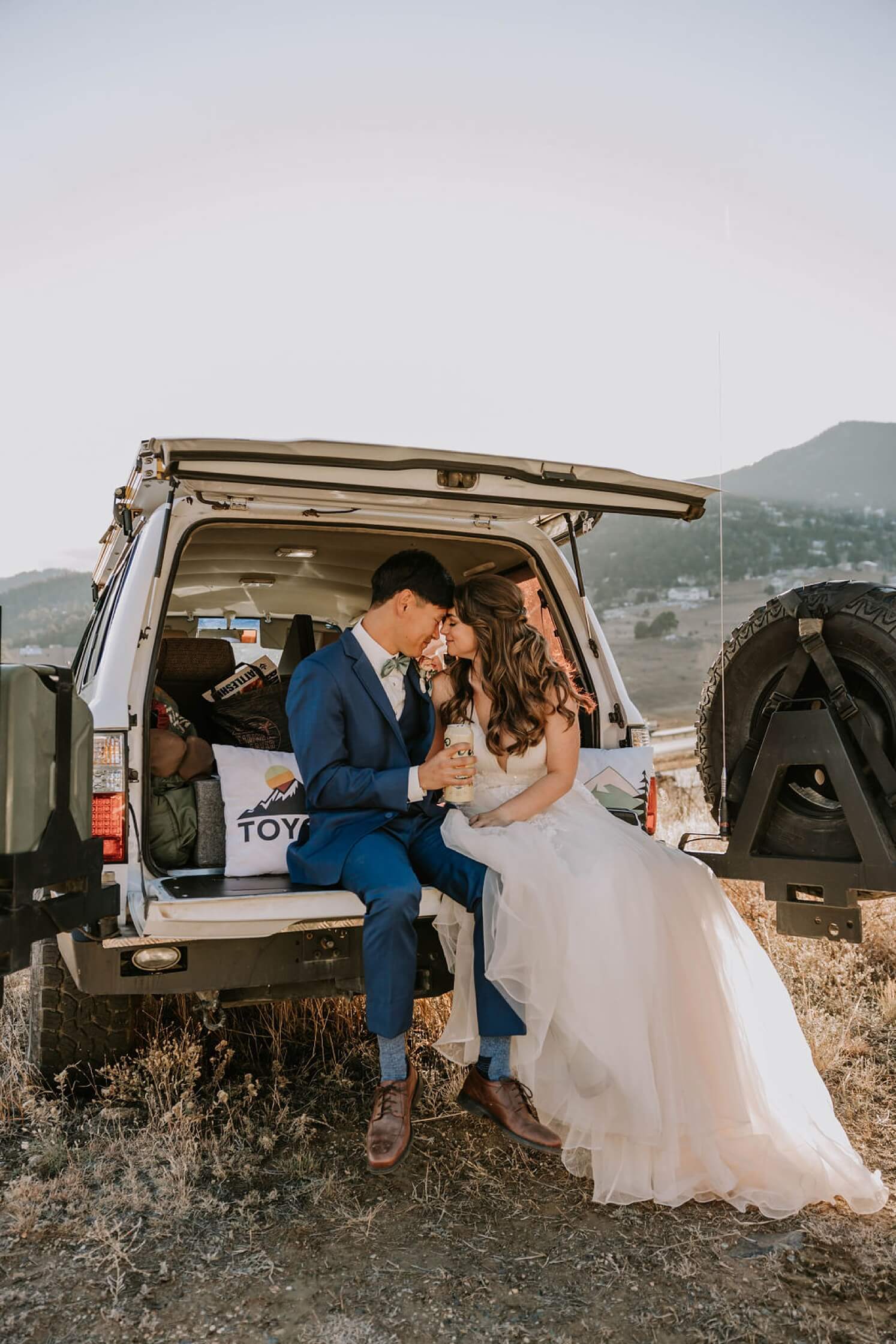 Bride and groom having a tailgate beer after Colorado elopement | McArthur Weddings and Events