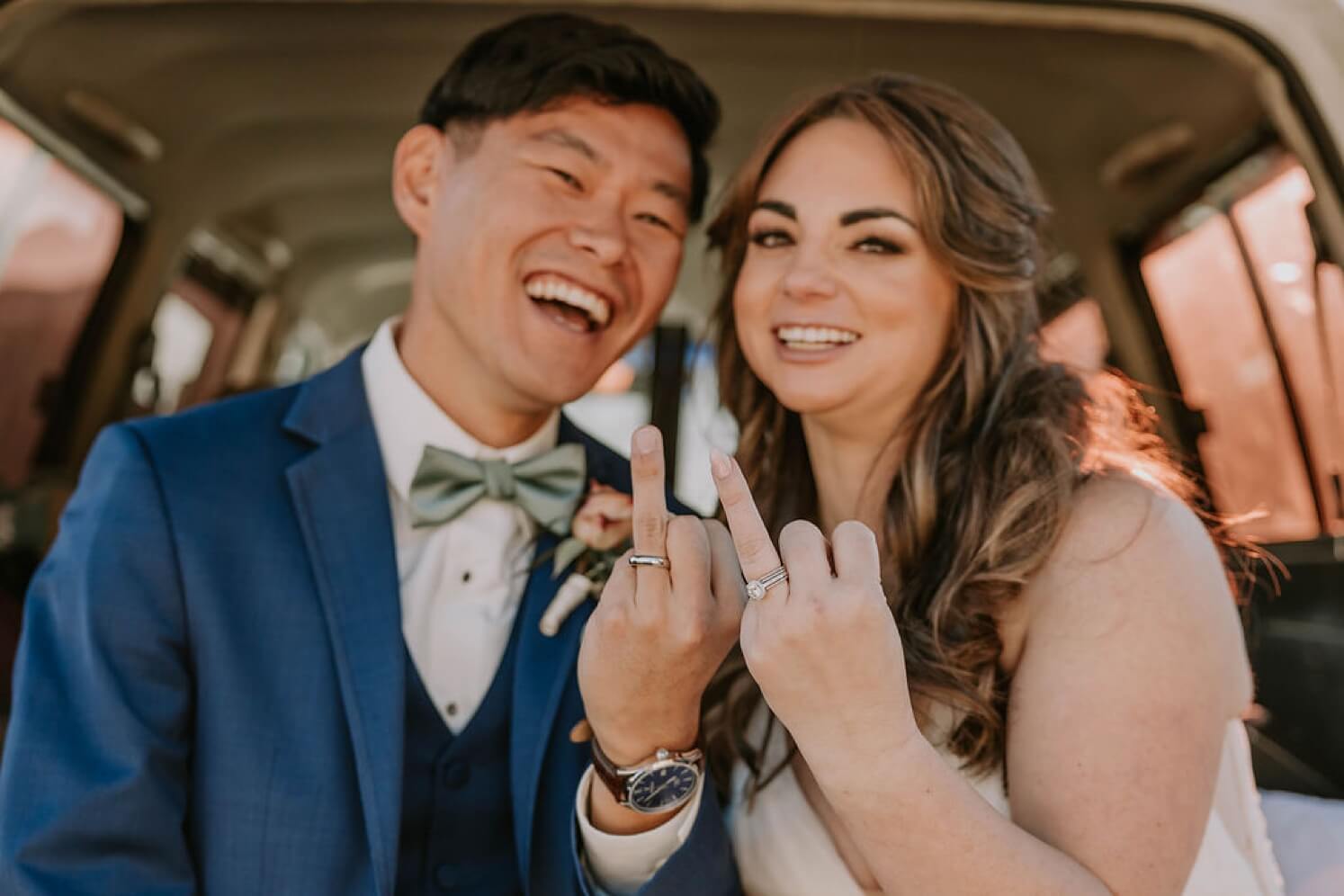Bride and groom showing off wedding rings after Colorado elopement | McArthur Weddings and Events