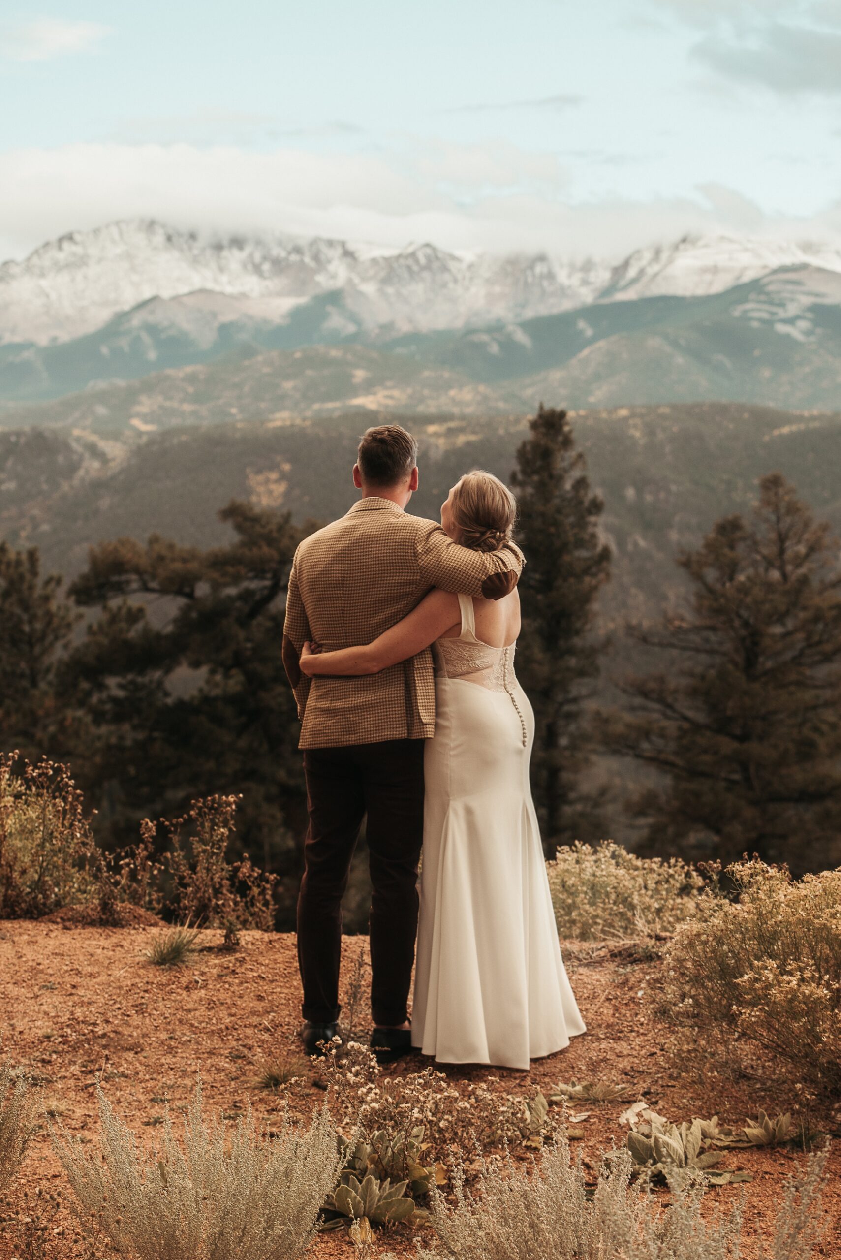 Bride and groom looking out at mountains at Airbnb wedding venue in Colorado