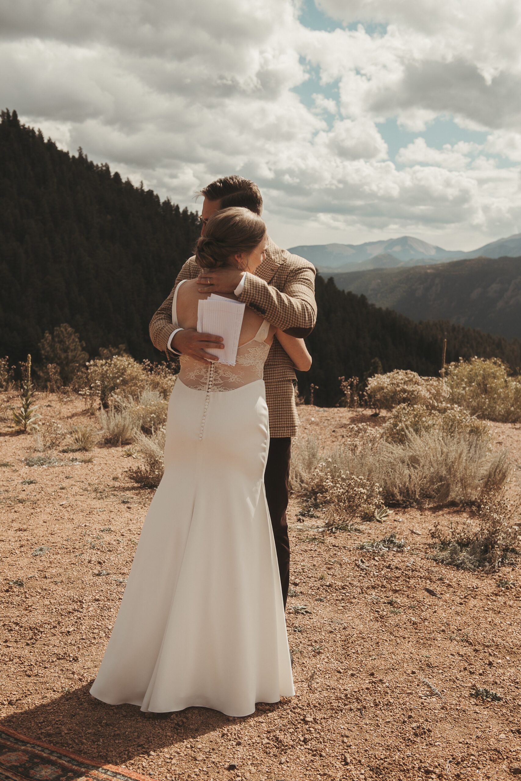 Bride and groom hugging at first look at Airbnb wedding venue in Colorado