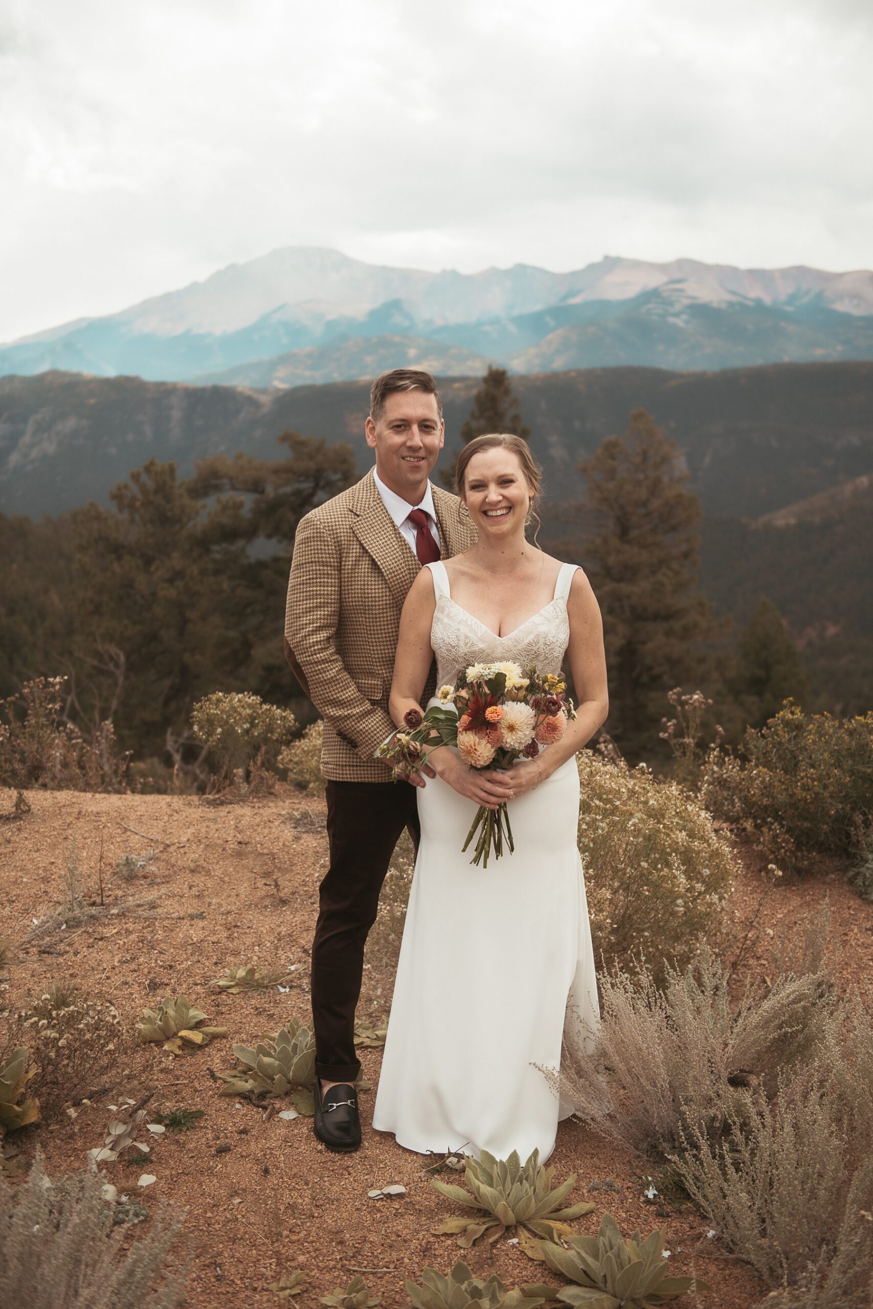 Bride and groom standing in front of mountains at Airbnb wedding venue in Colorado