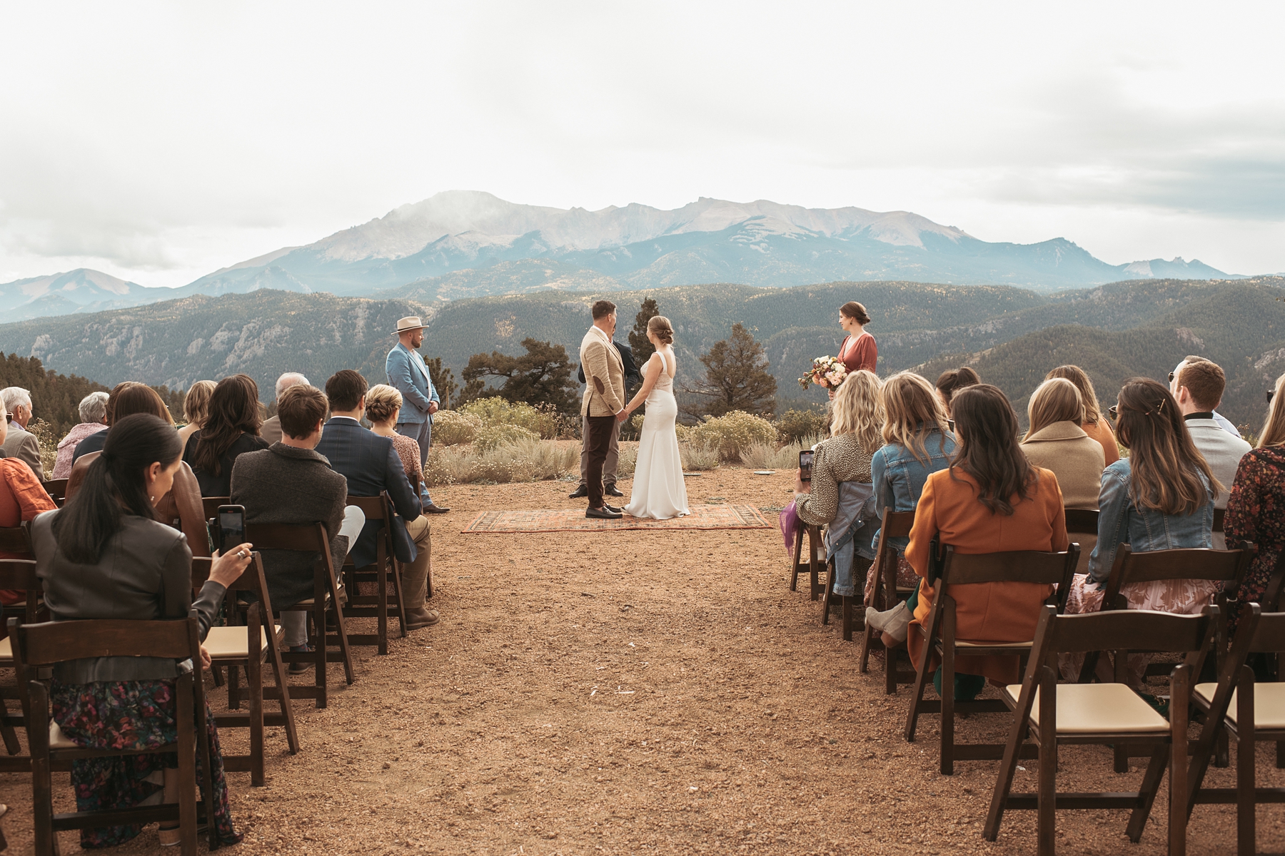Bride and groom holding hands during ceremony at Airbnb wedding venue in Colorado