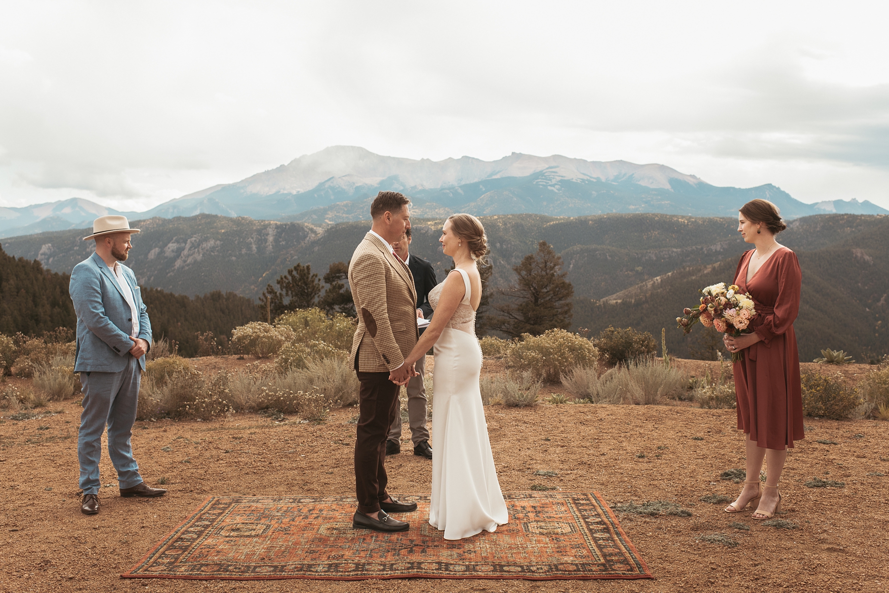 Bride and groom looking at each other and holding hands during ceremony at Airbnb wedding venue in Colorado