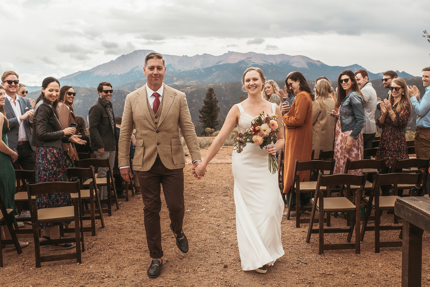 Bride and groom walking down the aisle at Airbnb wedding venue in Colorado