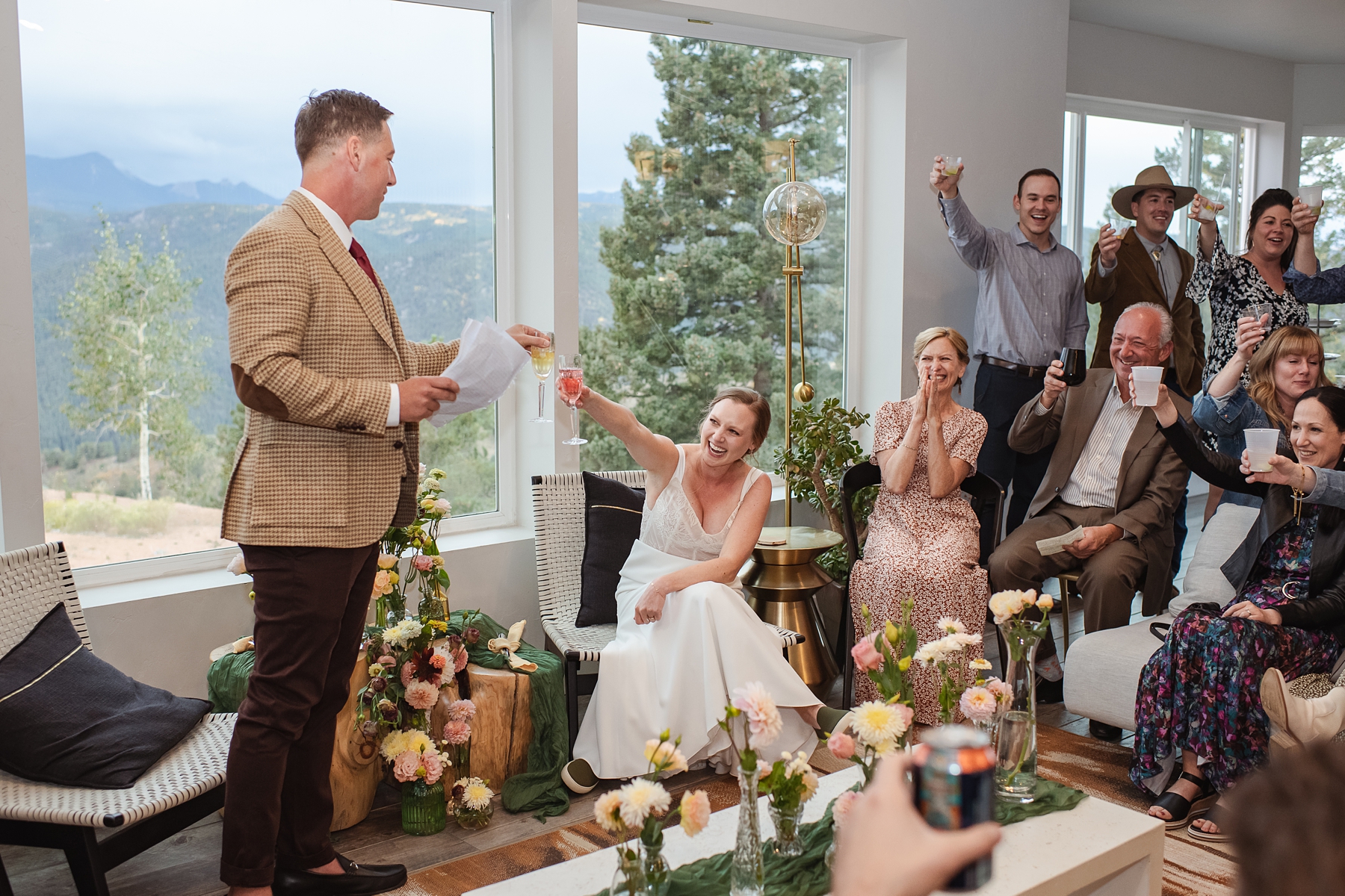 Wedding guests toasting to bride and groom's surprise pregnancy announcement at wedding reception 