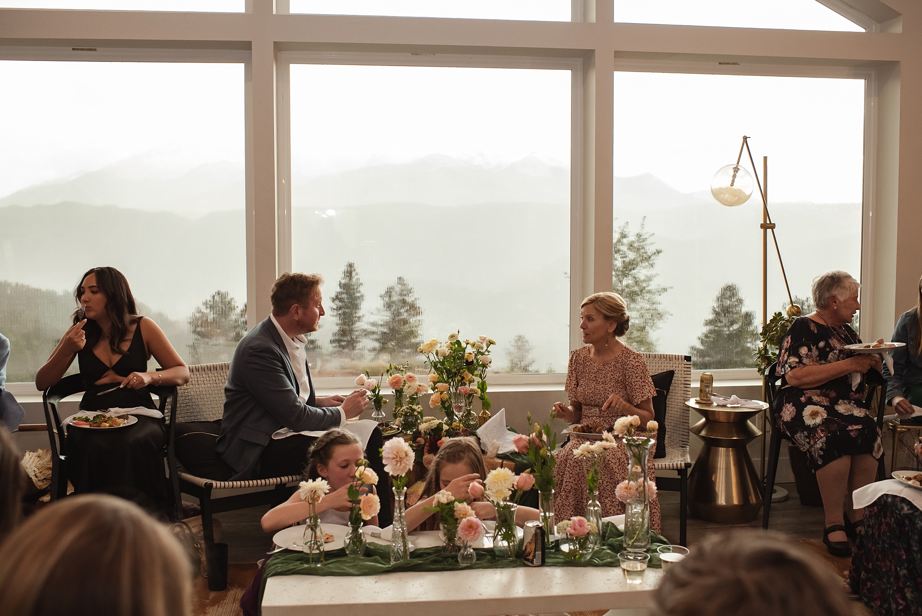 Wedding guests eating dinner at Airbnb wedding venue in Colorado