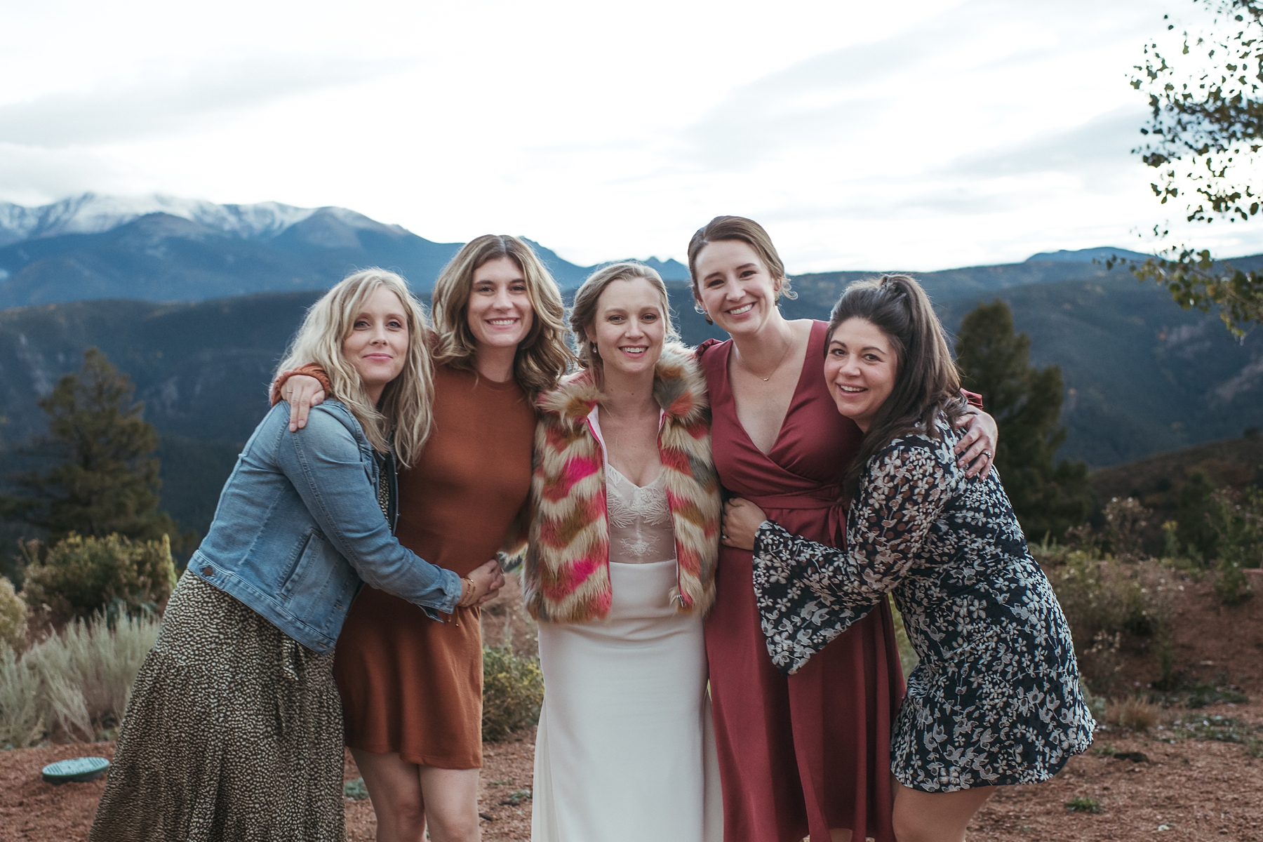 Bride with friends in front of mountains at Airbnb wedding venue in Colorado