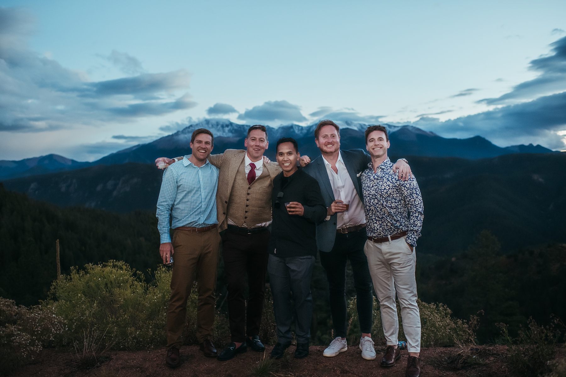 Groom with friends in front of mountains at Airbnb wedding venue in Colorado