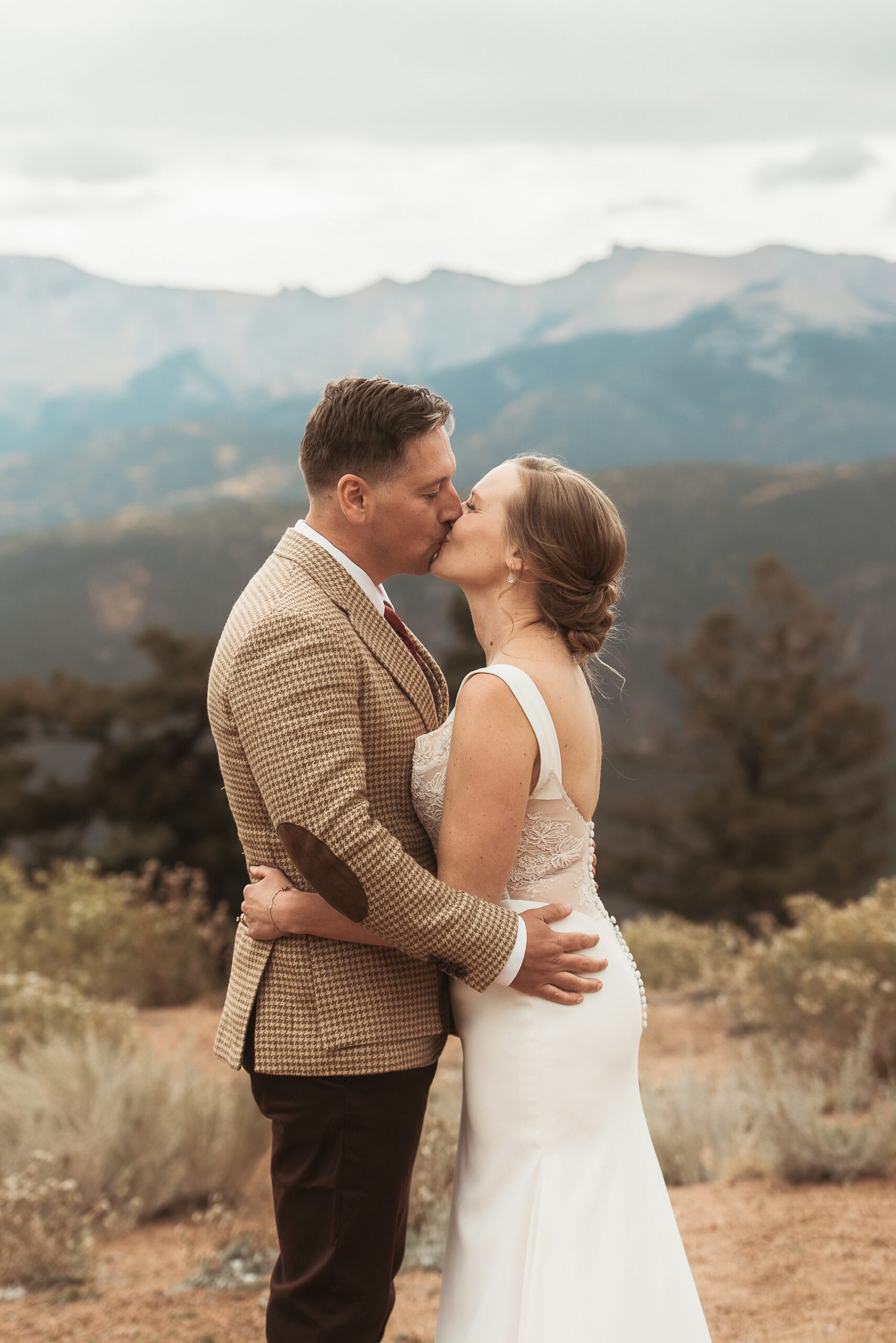 Brid enad groom's first kiss at Airbnb wedding venue in Colorado