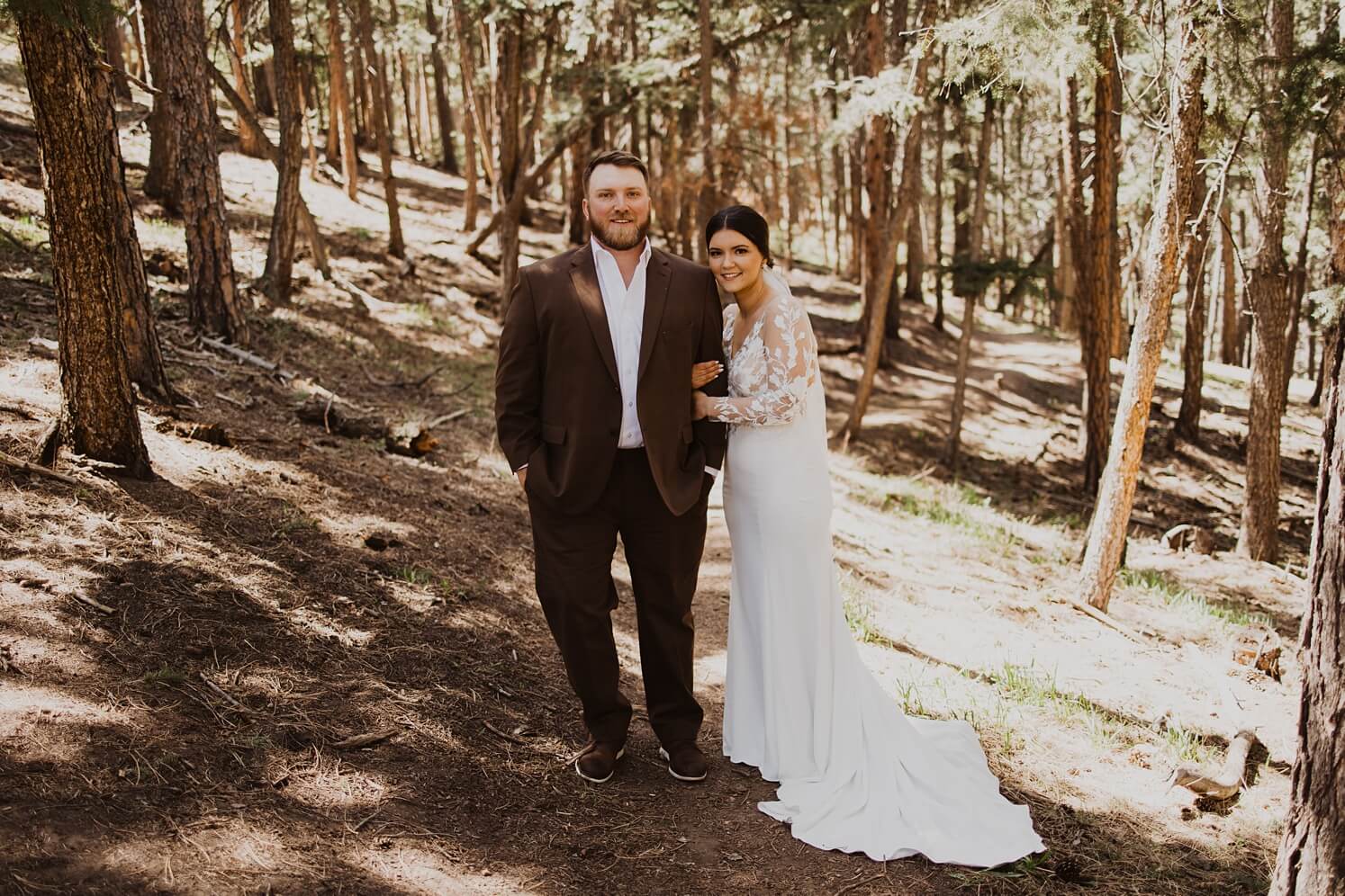 Bride and groom standing in forest at Evergreen wedding venue | McArthur Weddings and Events