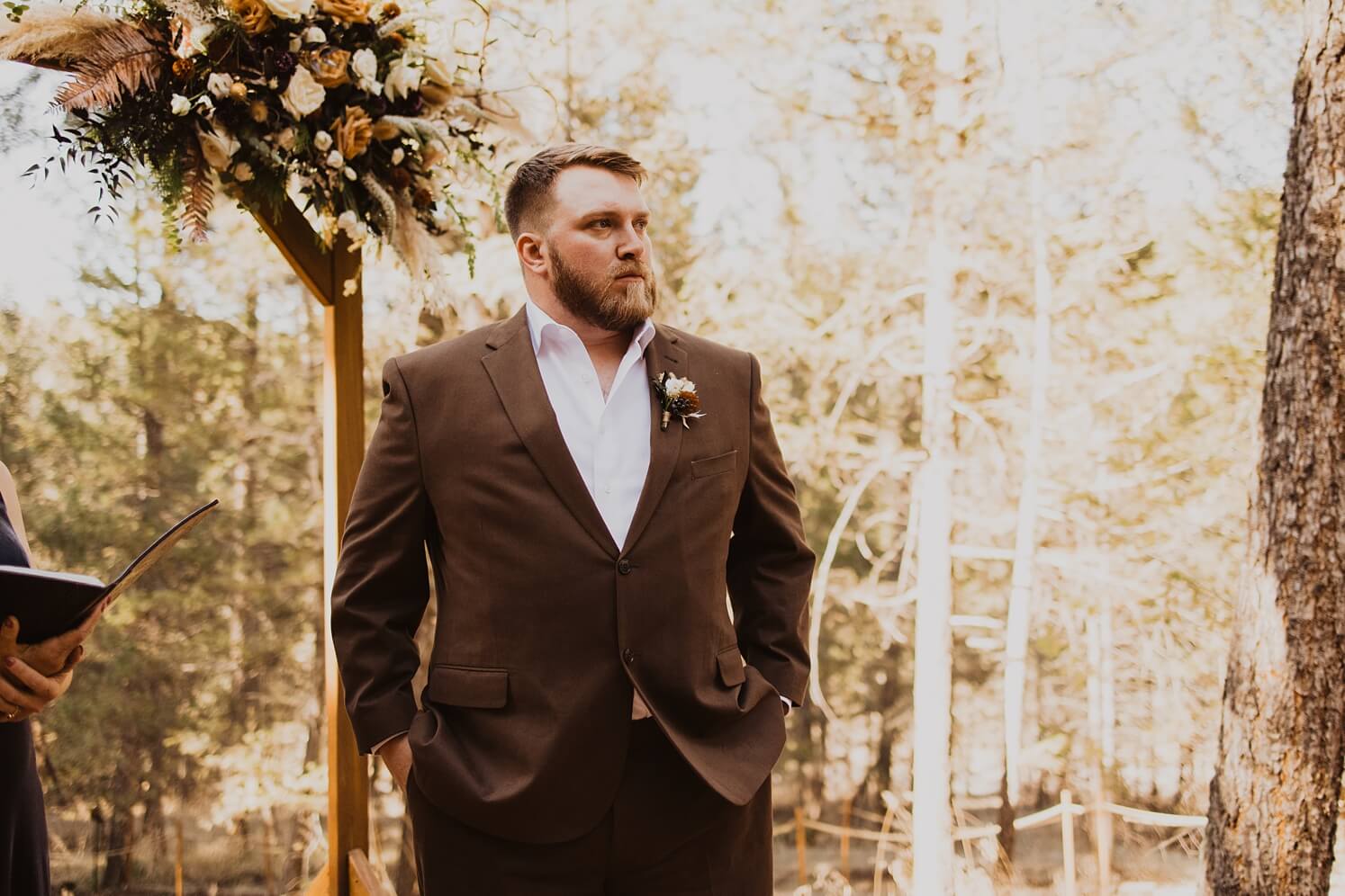Groom standing at altar watching bride walk down the aisle | McArthur Weddings and Events