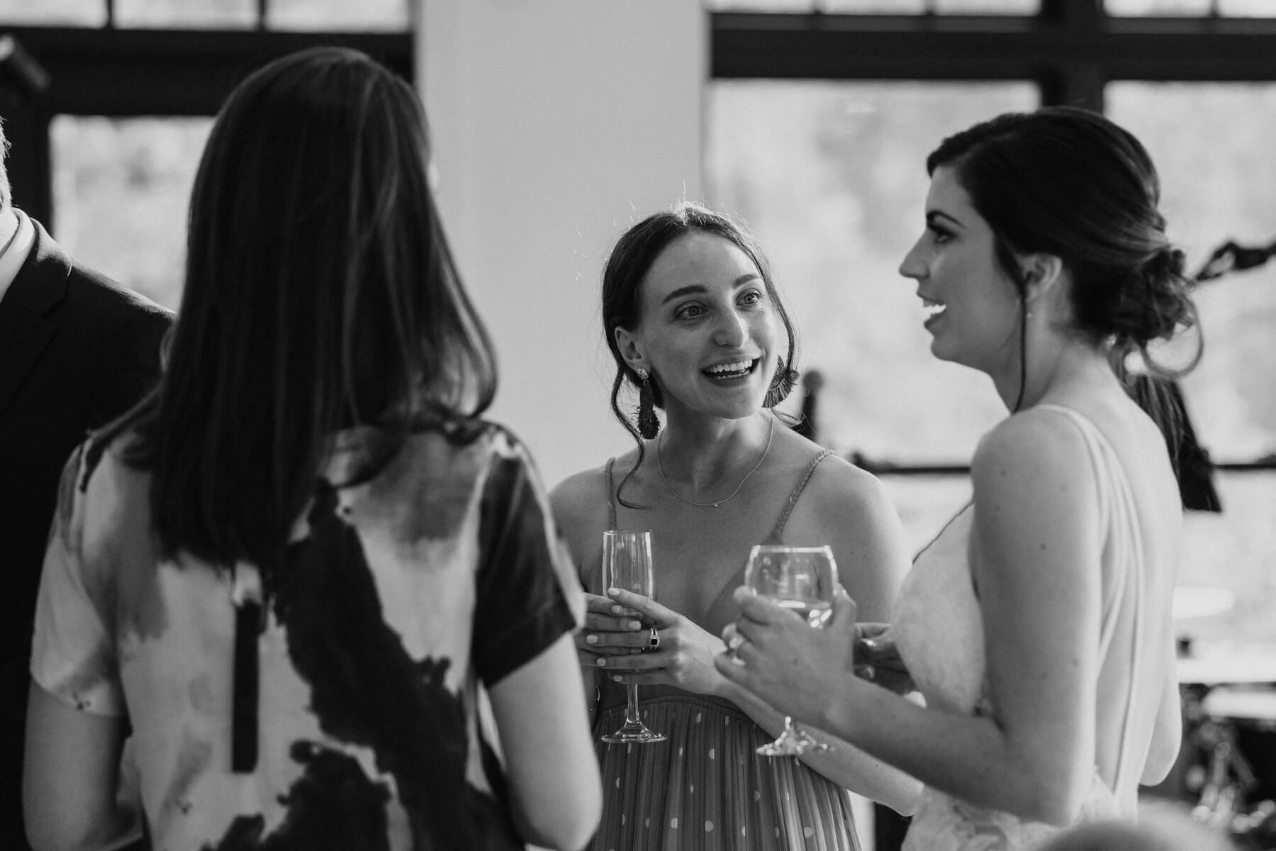 Bride talking to guests during wedding reception 